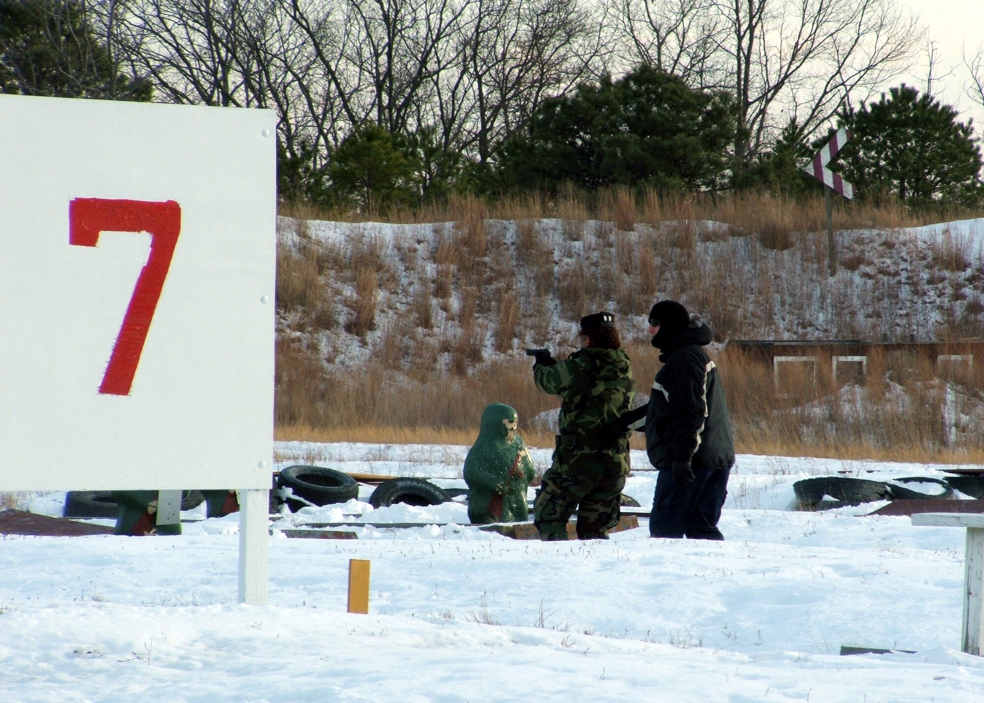 FORT DIX, N.J. (AFPN) -- Senior Airman Andrea Taylor fires a 9 mm pistol at range targets as part of the Rules of Engagement/Rules of Use of Force Tactical Training Seminar here. Airman Taylor was one of about 40 students attending the seminar held by the Air Mobility Warfare Center from Dec. 6 to 8. (U.S. Air Force photo by Tech. Sgt. Scott T. Sturkol)