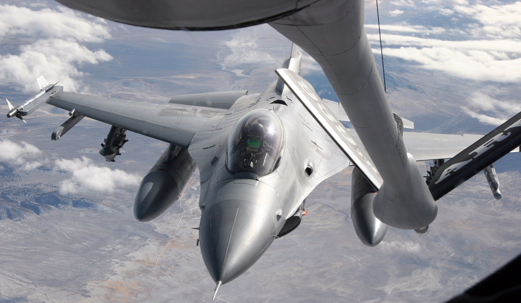 OVER UTAH (AFPN) -- An F-16 Fighting Falcon aircraft refuels with a KC-135 Stratotanker. The F-16 is with the 419th Fighter Wing at Hill Air Force Base, Utah. The KC-135 is with the 939th Air Refueling Wing in Portland, Ore. (U.S. Air Force photo by Master Sgt. Ruby Zarzyczny)