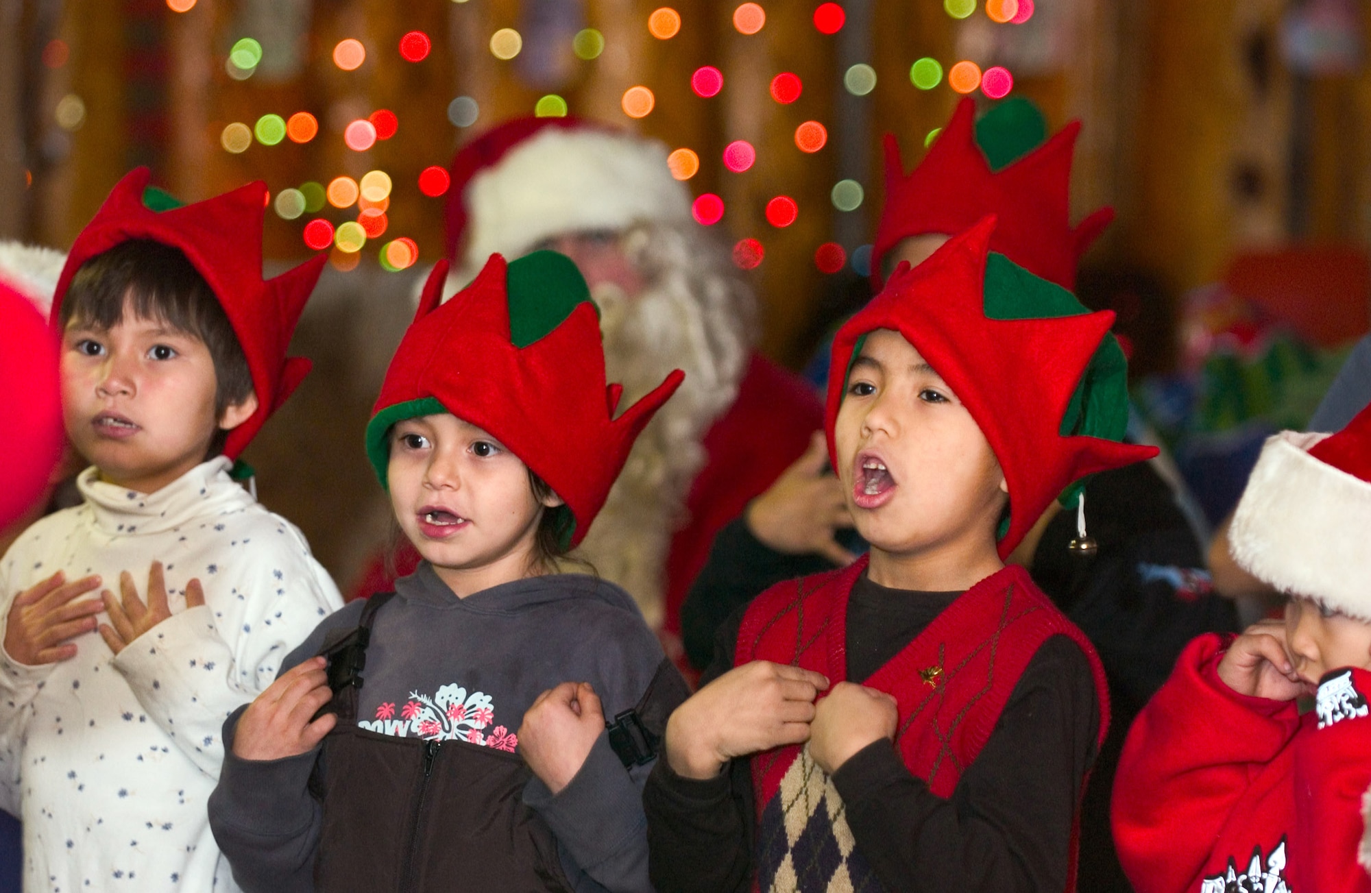 ARCTIC VILLAGE, Alaska -- Athabascan children sing carols for Airmen from Elmendorf Air Force Base, Alaska. The children and community gathered in the village town hall to share their culture with the visiting Airmen and their families. (U.S. Air Force photo by Airman 1st Class Garrett Hothan)