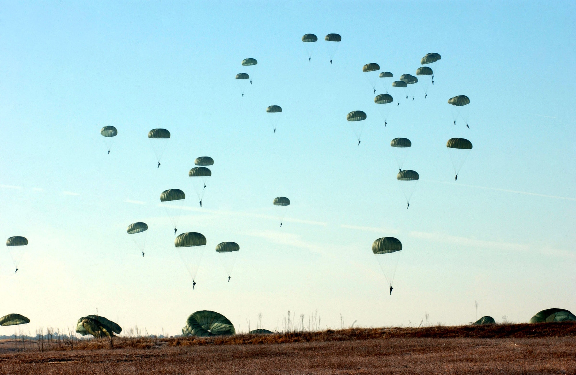 FORT BRAGG, N.C. (AFPN) -- Paratroopers with the 82nd Airborne Division land at Drop Zone Sicily here in the 8th Annual Randy Oler Memorial Operation Toy Drop. The event was designed to collect toys for the children of military families here and at Pope Air Force Base, N.C., as well as those in the surrounding communities. Paratroopers participated by donating a toy in exchange for a chance to jump with German and Irish military jumpers. To date, Operation Toy Drop has collected and distributed more than 14,000 toys. (U.S. Air Force photo by Senior Airman Richard Rose)
