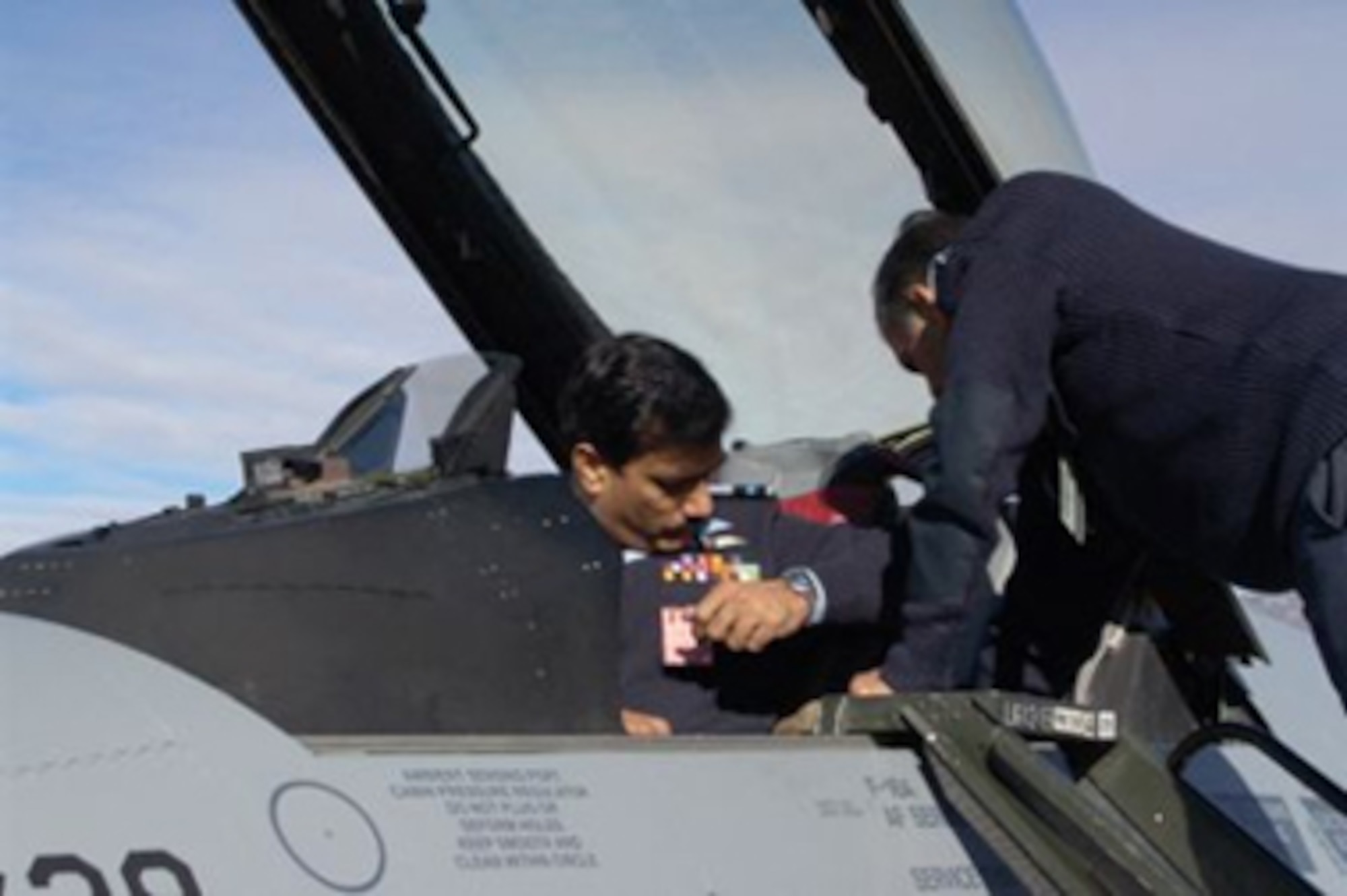 Pakistani Air Commodore (Brig. Gen.) Syed Hassan Raza, Director of F-16 Weapons System Management for F-16 Project Falcon, inspects one of the transfer aircraft at Hill AFB, Utah. (Air Force photo by Dane Anderson)

