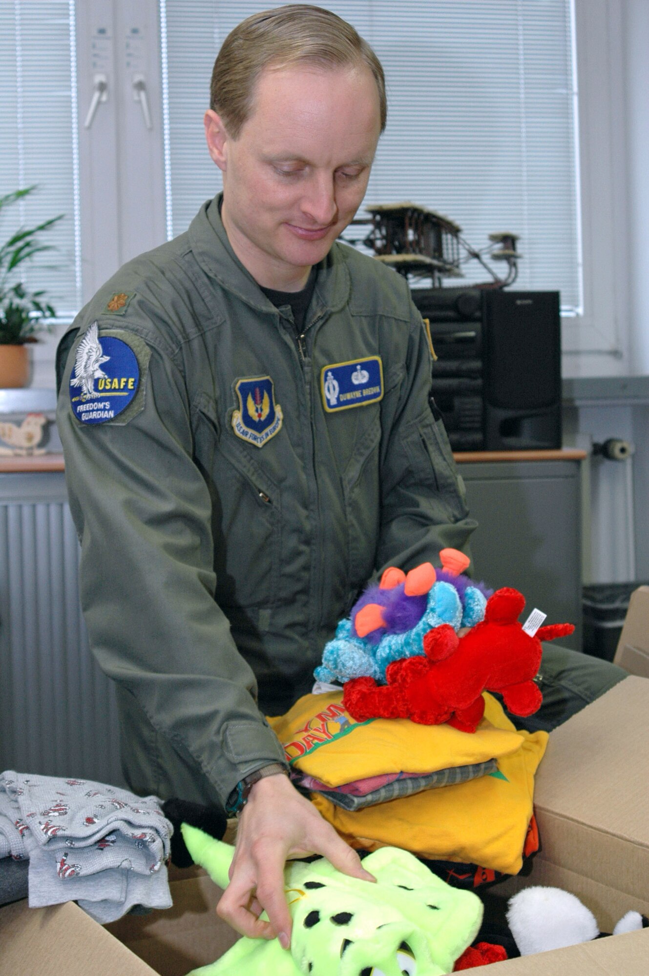 RAMSTEIN AIR BASE, Germany (AFPN) -- Maj. DuWayne Bredvik packs donated gifts being sent to schools and orphanages in Afghanistan. Major Bredvik is the chief of policy and doctrine for the U.S. Air Forces in Europe Plans and Programs Directorate. (U.S. Air Force photo by Capt. Jonathan Friedman)