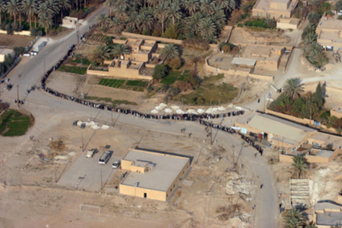 Iraqi voters line up outside a polling site in Barwana, Iraq, on Dec. 15, 2005. Iraqi citizens are voting to elect Iraq's first free, permanent parliamentary government. 