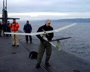 Air Force special operations forces from the 22nd and 23rd Special Tactics Squadrons prepare to launch a Pointer UAV from the deck of USS Alabama (SSBN 731) in the Pacific Ocean during a recent exercise to test special operations infiltration and rescue tactics. The joint effort also tests the capabilities of the SSGN class submarines entering service next year. The SSGN class submarines are being converted from ballistic missile submarines to guided missile submarines with new capabilities.  US Navy photo by FTCM (SS) Daniel J. Niclas
