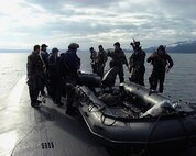 Air Force special operations forces from the 22nd and 23rd Special Tactics Squadrons prepare to launch an inflatable boat from the deck of USS Alabama (SSBN 731) in the Pacific Ocean during a recent exercise to test special operations infiltration and rescue tactics. The joint effort also tests the capabilities of the SSGN class submarines entering service next year. The SSGN class submarines are being converted from ballistic missile submarines to guided missile submarines with new capabilities.  US Navy photo by FTCM (SS) Daniel J. Niclas