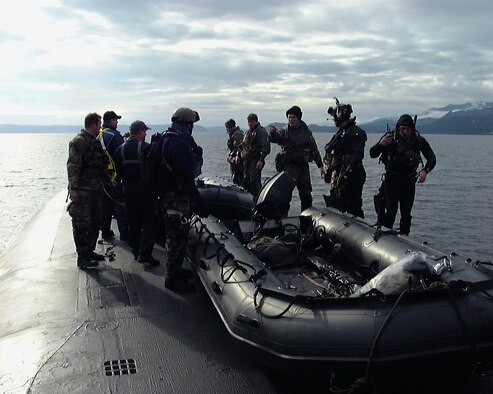Air Force special operations forces from the 22nd and 23rd Special Tactics Squadrons prepare to launch an inflatable boat from the deck of USS Alabama (SSBN 731) in the Pacific Ocean during a recent exercise to test special operations infiltration and rescue tactics. The joint effort also tests the capabilities of the SSGN class submarines entering service next year. The SSGN class submarines are being converted from ballistic missile submarines to guided missile submarines with new capabilities.  US Navy photo by FTCM (SS) Daniel J. Niclas

