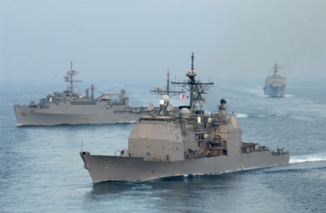 The guided missile cruiser USS Port Royal (CG 73) (foreground), amphibious transport dock USS Ogden (LPD 5) (left), and the dock landing ship USS Germantown (LSD 42) maneuver from a formation as they operate in the Pacific Ocean on Dec. 13, 2005. The ships and Expeditionary Strike Group 3 are underway off the coast of Southern California for a composite unit training exercise. 