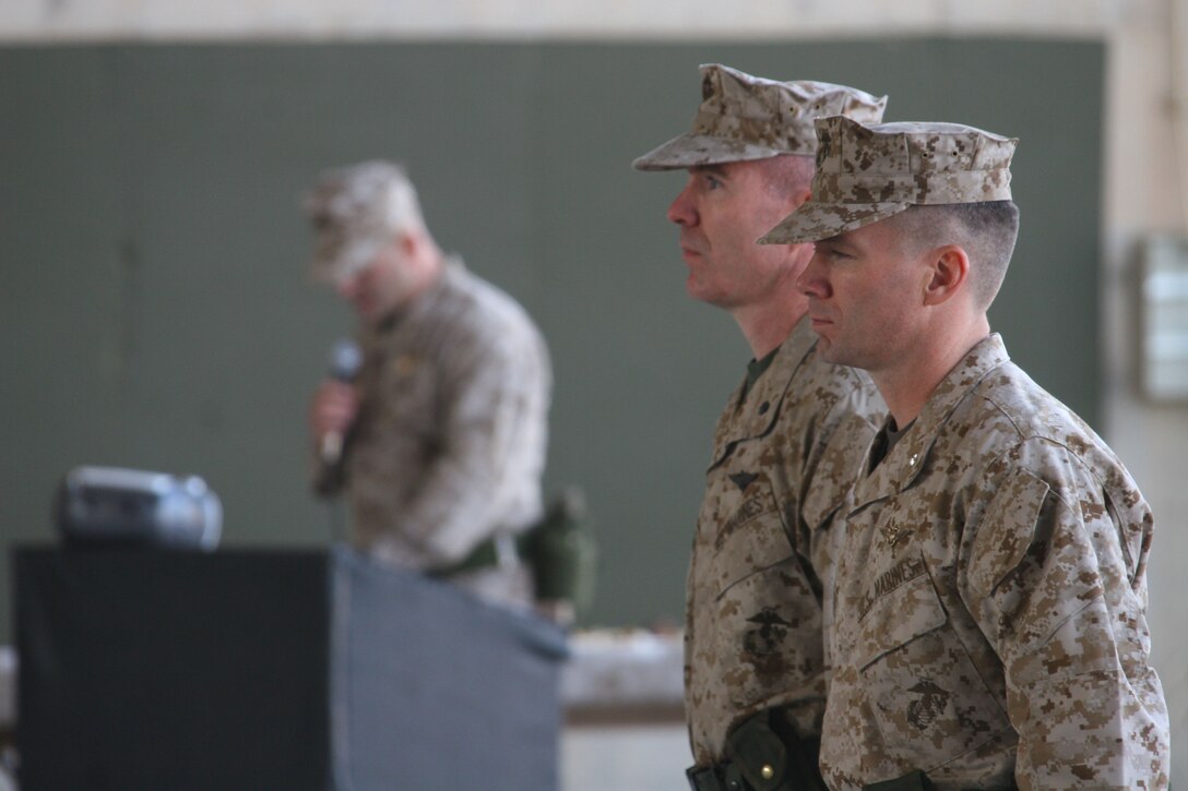 Lieutenant Col. Leo Kilgore, a Yukon, Okla., native, and Lt. Col. John G. McGonagle, a Simsbury, Conn., native, stand at attention during a change of command ceremony, Dec. 18, at Al Asad, Iraq. After two years as the commanding officer of Marine Medium Helicopter Squadron 774, McGonagle passed the colors and command of the squadron to Kilgore, during the ceremony.