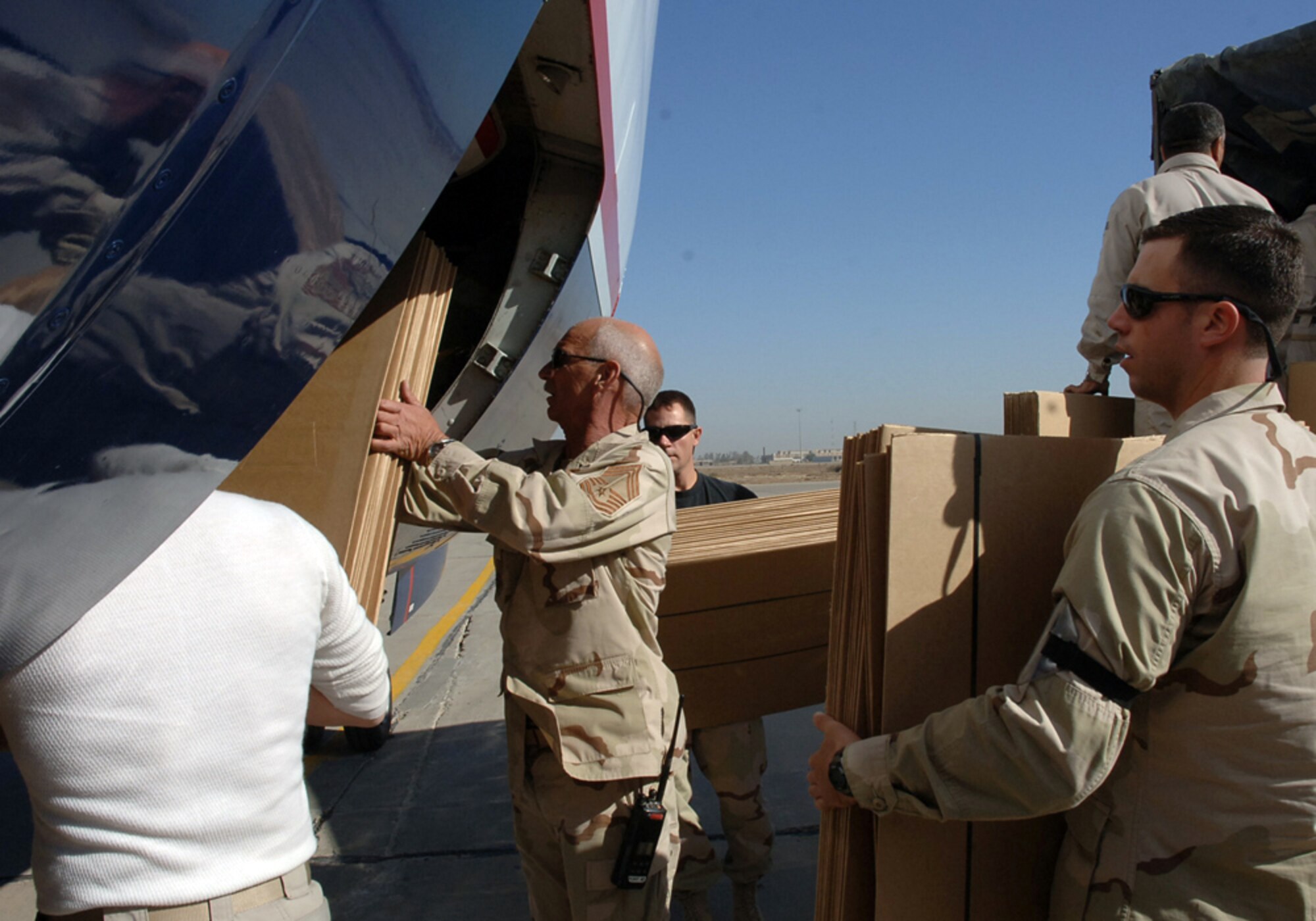 BAGHDAD, Iraq (AFPN) -- Airmen load election materials aboard a contract flight that will be going to polling site.  The Airmen are with the 447th Expeditionary Logistics Readiness Squadron.  (U.S. Air Force photo by Master Sgt. Randy L. Mitchell) 
