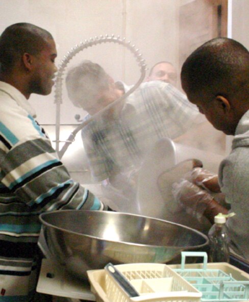 DERRY, N.H. (AFPN) - Airmen clean pots and pans at the Sonshine Soup Kitchen here.  Once every two months, at least five Airmen from nearby New Boston Air Force Station volunteer to cook, serve meals and clean dishes at the kitchen. The base has supported the soup kitchen's mission for more than six years. (U.S. Air Force photo)