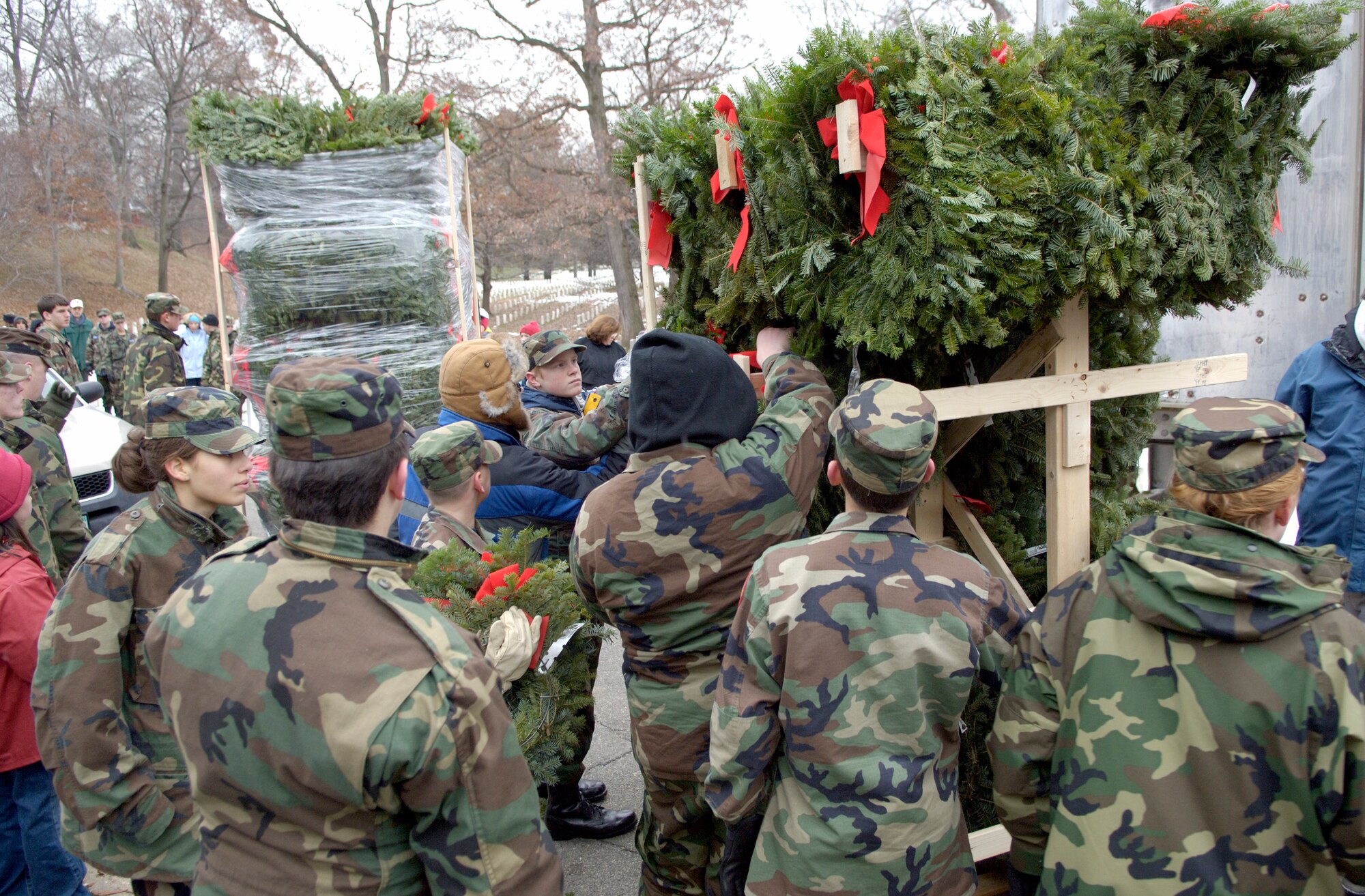 ARLINGTON, Va. (AFPN) -- Hundreds of volunteers gathered at Arlington National Cemetery to place more than 5,000 donated Christmas wreaths on head stones. The 14th annual wreath laying event is the result of Worcester Wreath Company's owner Morrill Worcester's, childhood dream of doing something to honor those laid to rest in the national cemetery.. (U.S. Air Force photo by Master Sgt. Jim Varhegyi)
