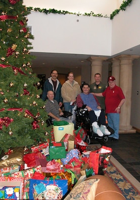 Air Force Reserve 'Angels' (Back row left to right) SMSgt. Bob Gaspar, SSgt. Colleen Rehm and Maj. Jimmy Wolfe pose with residents of the Norman Veterans Center during 2004.  Reservists from the 507th Air Refueling Wing and 513th Air Control Group surpassed last year's 179 gifts to provide 254 gifts for center residents in 2005 year.  A party for the veterans will be held December 22.