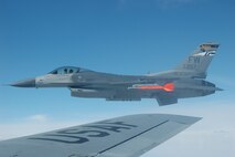 An F-16 fighter waits for its turn to be refueled by a  KC-135R Stratotanker from the 434th Air Refueling Wing, Air Force Reserve Command, Grissom Air Reserve Base, Ind., during an aerial refuelng mission.