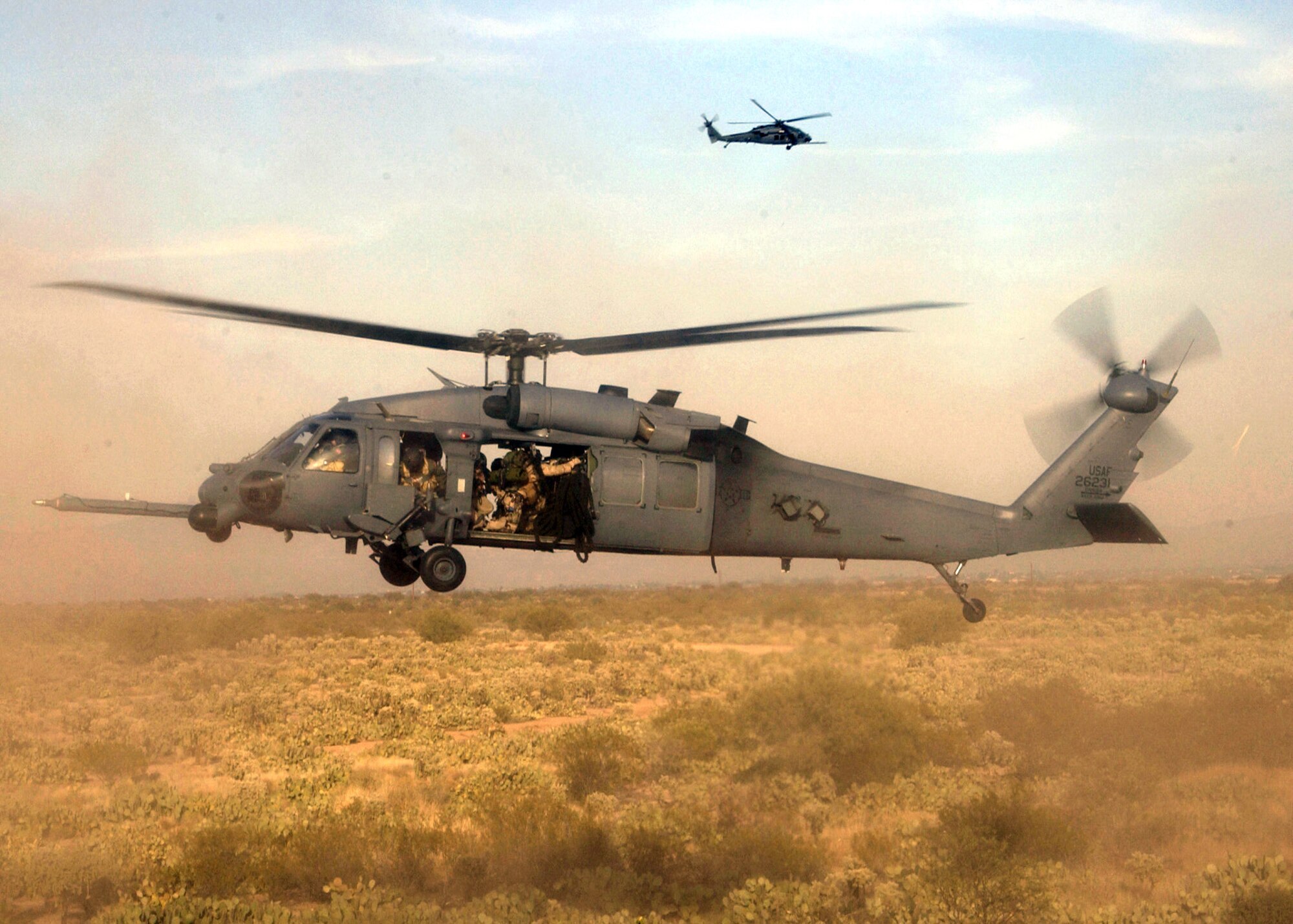DAVIS-MONTHAN AIR FORCE BASE, Ariz. (AFPN) -- Pararescuemen from the 306th and 48th Rescue Squadrons prepare to fast rope from an HH-60 Pave Hawk helicopter in an exercise here. The combined training exercise simulated the rescue of "wounded hostages" from an enemy forces' location. (U.S. Air Force photo by Airman 1st Class Veronica Pierce) 