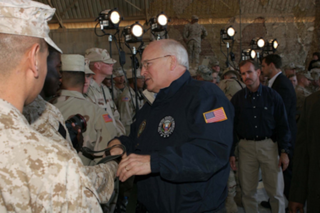 Vice President Dick Cheney shakes hands as he greets service members after speaking to U.S. Marines, sailors, and soldiers in a hangar on Al Asad Air Base, Iraq, on Dec. 18, 2005. Cheney made a surprise visit to Iraq where he met with U.S. troops, military commanders and Iraqi leaders. 