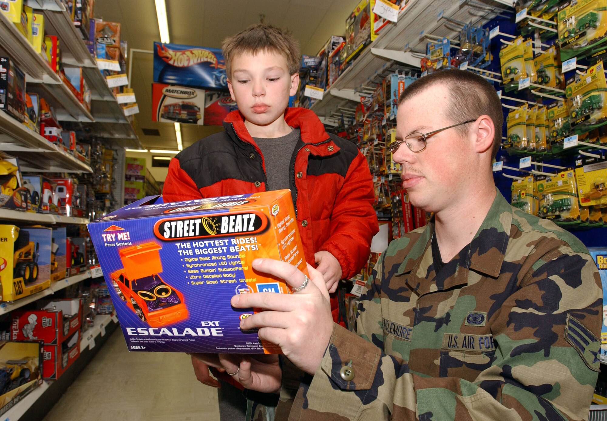 MINOT AIR FORCE BASE, N.D. -- Senior Airman John McLemore Christmas shops with Jeffery Dunn, a local youth as part of the base's annual "Shop with a Cop" program.  Airman McElmore is with the 5th Security Forces Squadron. (U.S. Air Force photo by Airman Joe Rivera)