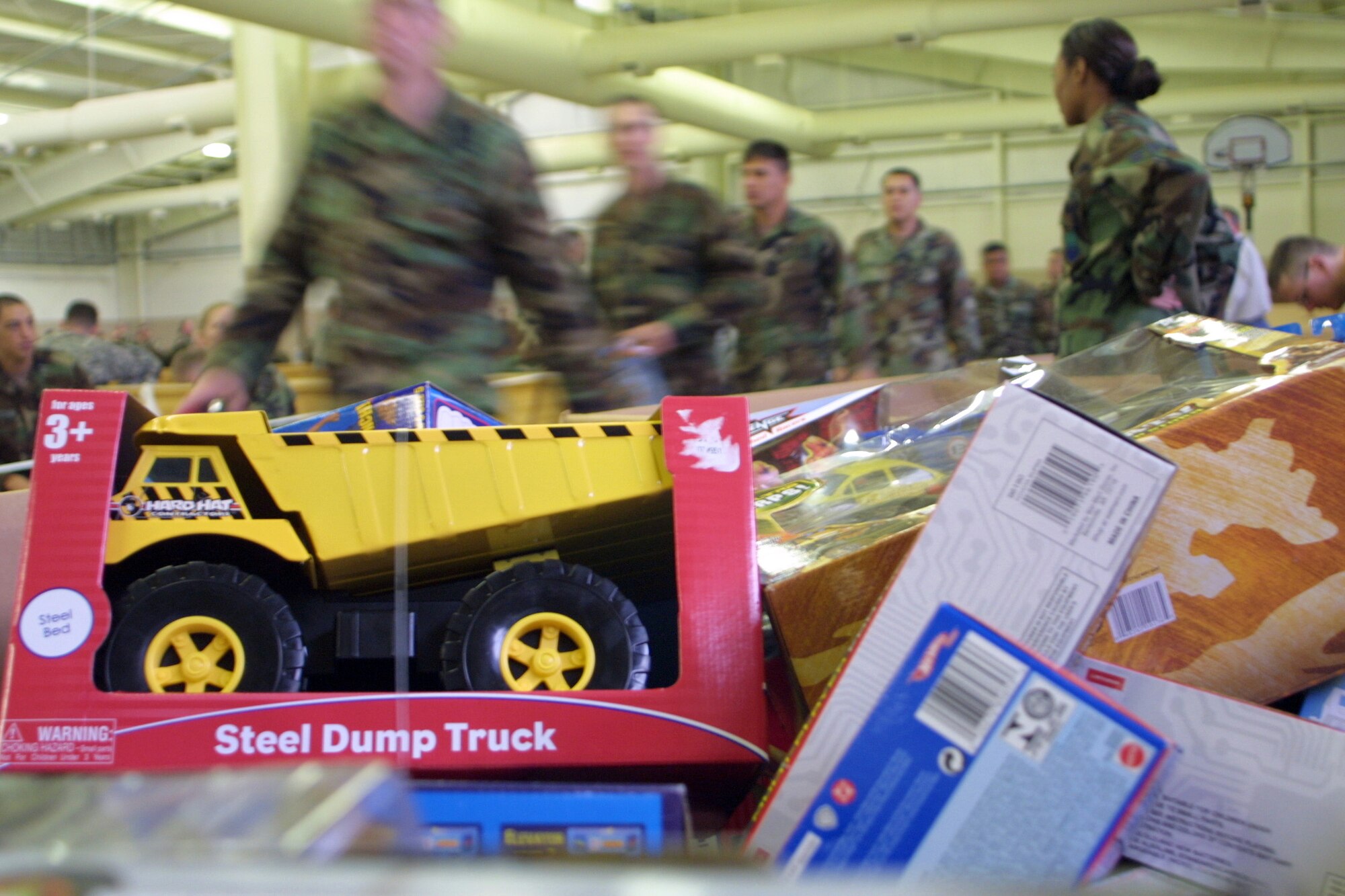POPE AIR FORCE BASE, N.C. (AFPN) -- Soldiers hurry through the processing line at Operation Toy Drop. About 3,600 toys were donated to local families in need. In exchange for donations, the Soldiers got to jump with foreign jumpmasters, allowing them to earn either German or Irish jump wings. (U.S. Air Force photo by Lisa Terry McKeown)