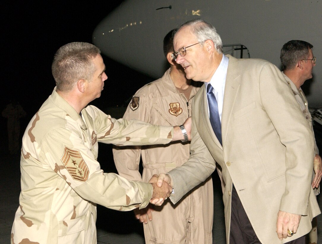 SOUTHWEST ASIA (AFPN) -- Secretary of the Air Force Michael W. Wynne shakes hands with Chief Master Sgt. Dwayne Hopkins, 379th Air Expeditionary Wing command chief.  This is Secretary Wynne's first tour to the region.  (U.S. Air Force photo by Staff Sgt. Rhiannon Willard) 