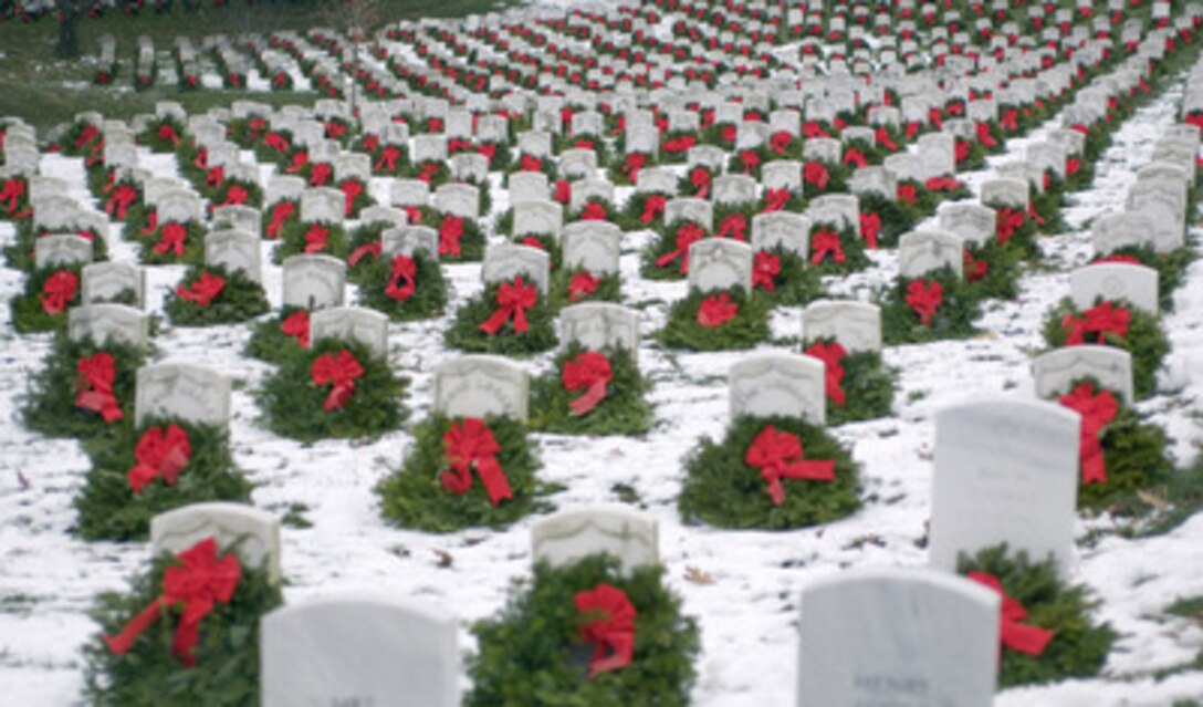 Thousands of Christmas wreaths are nestled against headstones in Section 27 at Arlington National Cemetery in Arlington, Va., on Dec. 15, 2005. Hundreds of volunteers gathered at Arlington to place more than five thousand donated Christmas wreaths on head stones in the cemetery. The 14th annual wreath laying event is a result of Worcester Wreath Company owner Morrill Worcester's boyhood dream of doing something to honor those laid to rest in the National Cemetery. 