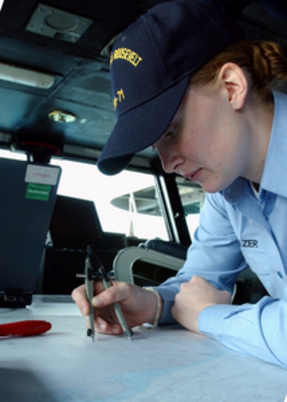 Navy Petty Officer 3rd Class Sarah Eleazer plots the position of the USS Theodore Roosevelt (CVN 71) on a chart in the ship's the navigation bridge on Dec. 16, 2005. Roosevelt and its embarked Carrier Air Wing 8 are conducting maritime security operations in the Persian Gulf. Eleazer is a Navy quartermaster onboard the aircraft carrier. 