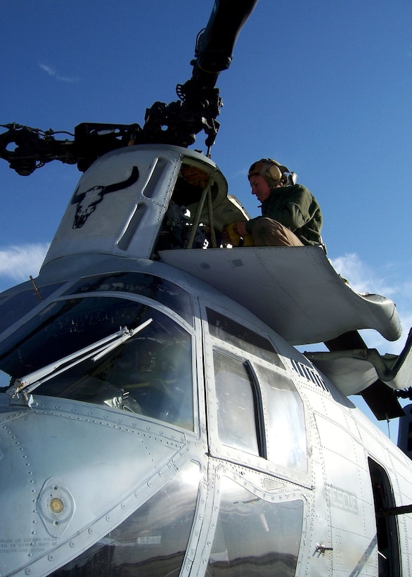 Corporal Jacob McGuire, a CH-46 Sea Knight crew chief, inspects his helicopter after arriving in Iraq, Dec. 21, 2005.  McGuire is with Marine Medium Helicopter Squadron 261 (Rein.), the aviation combat element of the 22nd Marine Expeditionary Unit (Special Operations Capable).