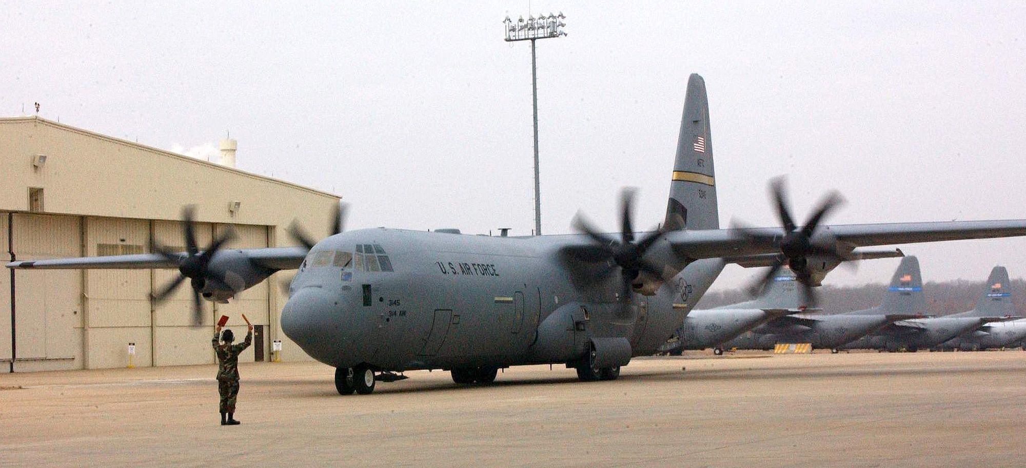 LITTLE ROCK AIR FORCE BASE, Ark. (AFPN) -- A crew chief marshals one of the last two C-130J Hercules aircraft assigned here. The aircraft arrived today in a two-ship formation. The base now has all seven assigned aircraft. (U.S. Air Force photo)