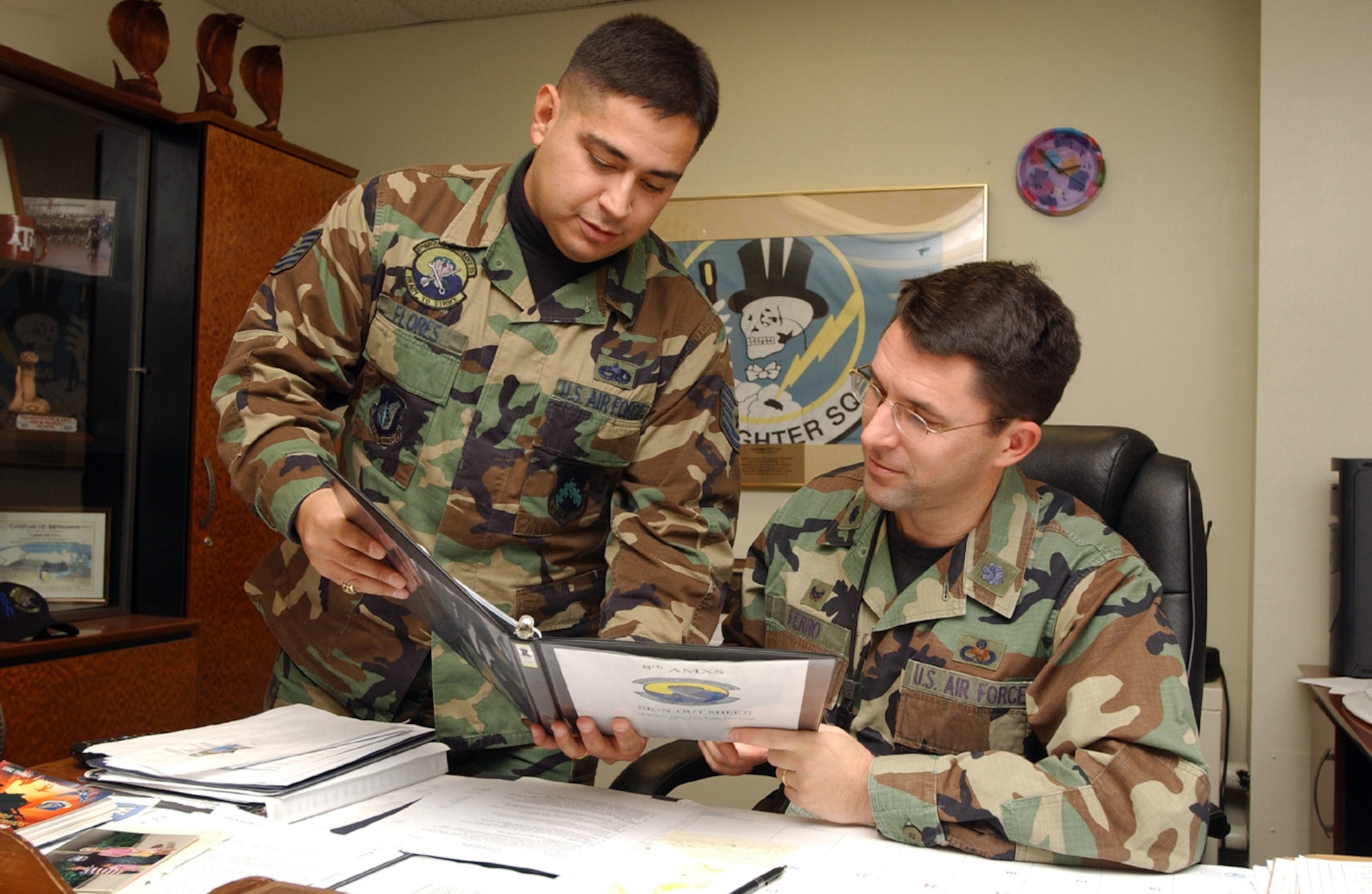 KUNSAN AIR BASE, South Korea (AFPN) -- Lt. Col. William Ferro, 8th Aircraft Maintenance Squadron commander, right, reviews a technical order with Tech. Sgt. Rodolfo "Rudy" Flores. Sergeant Flores recently received his second masters degree. (U.S. Air Force photo by Senior Airman Joshua DeMotts) 