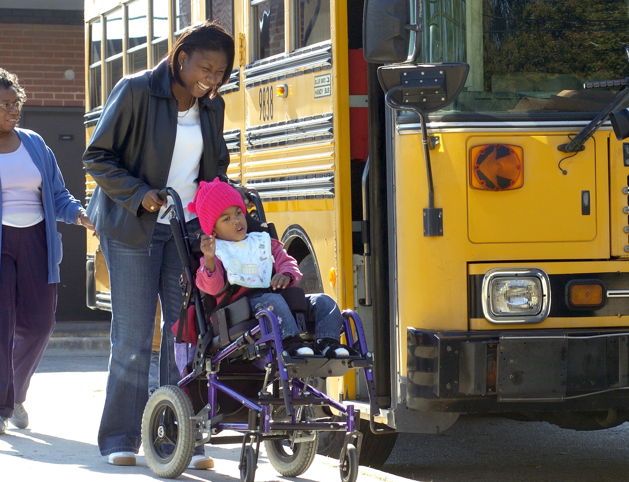 SAVANNAH, Ga., (AFPN) -- Diane Hayes wheels her daughter Kiera from school to physical and speech therapy here. The Hayes family was forced to evacuate Keesler Air Force Base, Miss., a day before Hurricane Katrina hit the Gulf Coast. Her husband, Staff Sgt. Herbert Hayes Jr., who returned on emergency leave after the storm, remains stationed in South Korea.  Her daughter's school loaned Kiera a wheelchair until renter's insurance can replace the one ruined by Katrina. (U.S. Air Force photo by Senior Airman Brian Ferguson)
