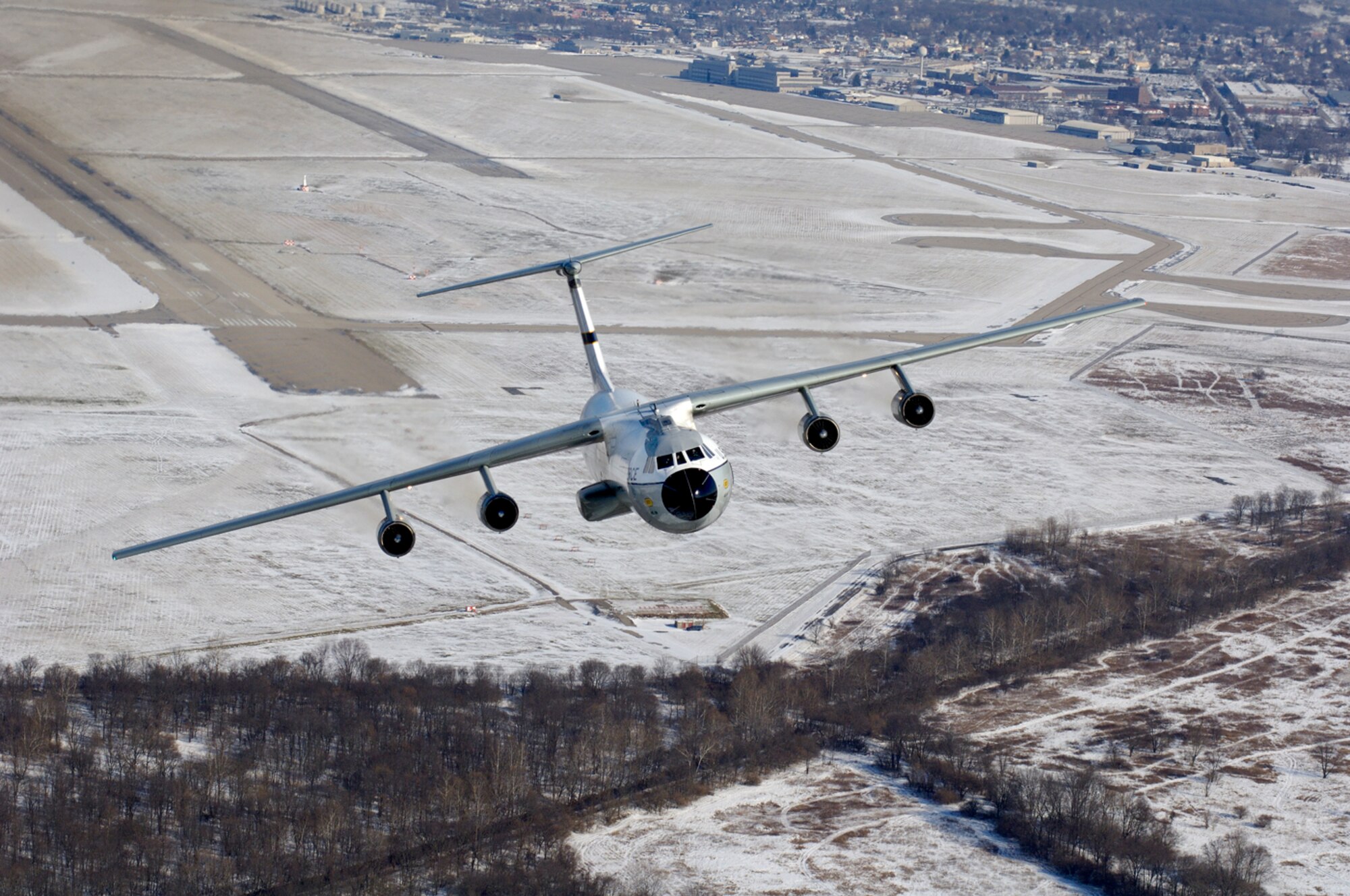 A C-141 Starlifter aircraft, better known as the Hanoi Taxi, flies over towards its soon-to-be new home at the National Museum of the U.S. Air Force adjacent to Wright-Patterson AFB, Ohio, Dec. 13.  This particular aircraft gained fame when it was used to return American prisoners of war back home at the end of the Viet Nam War.  As the last operational C-141 in Air Force Reserve Command's 445 Airlift Wing, the historic aircraft is scheduled to retire and be dedicated at the museum May 5-6.  The Reserve wing started replacing its C-141s with C-5 cargo aircraft in October and plan to have a total of 11 C-5s by April 2007.  (Courtesy Photo by John Rossino)

