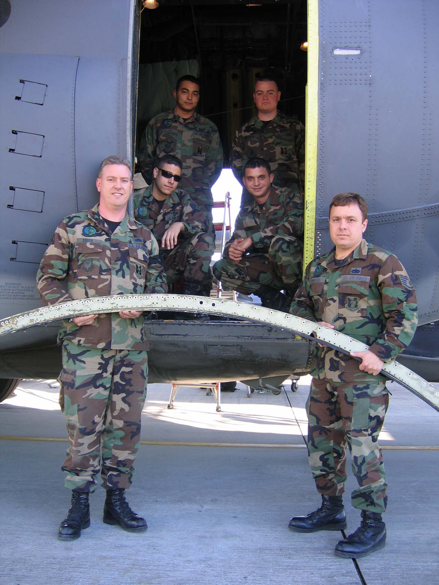 (Bottom to top) Tech Sgt. Patrick Smith, Staff Sgt. Thomas Downward, Staff Sgt. Christopher Ortega, Staff Sgt. Nicholas Souza, Airman 1st Class Bryan Bowers and Staff Sgt. Ivan Sterpin, 347th Aircraft Maintenance Squadron at Moody Air Force Base, Ga., completed depot-level maintenance Dec. 2 on a 347th Rescue Wing's HC-130P/N. They completed the repairs 20 days ahead of schedule saving the Air Force approximately $30,000. (Photo by Senior Airman S.I. Fielder)