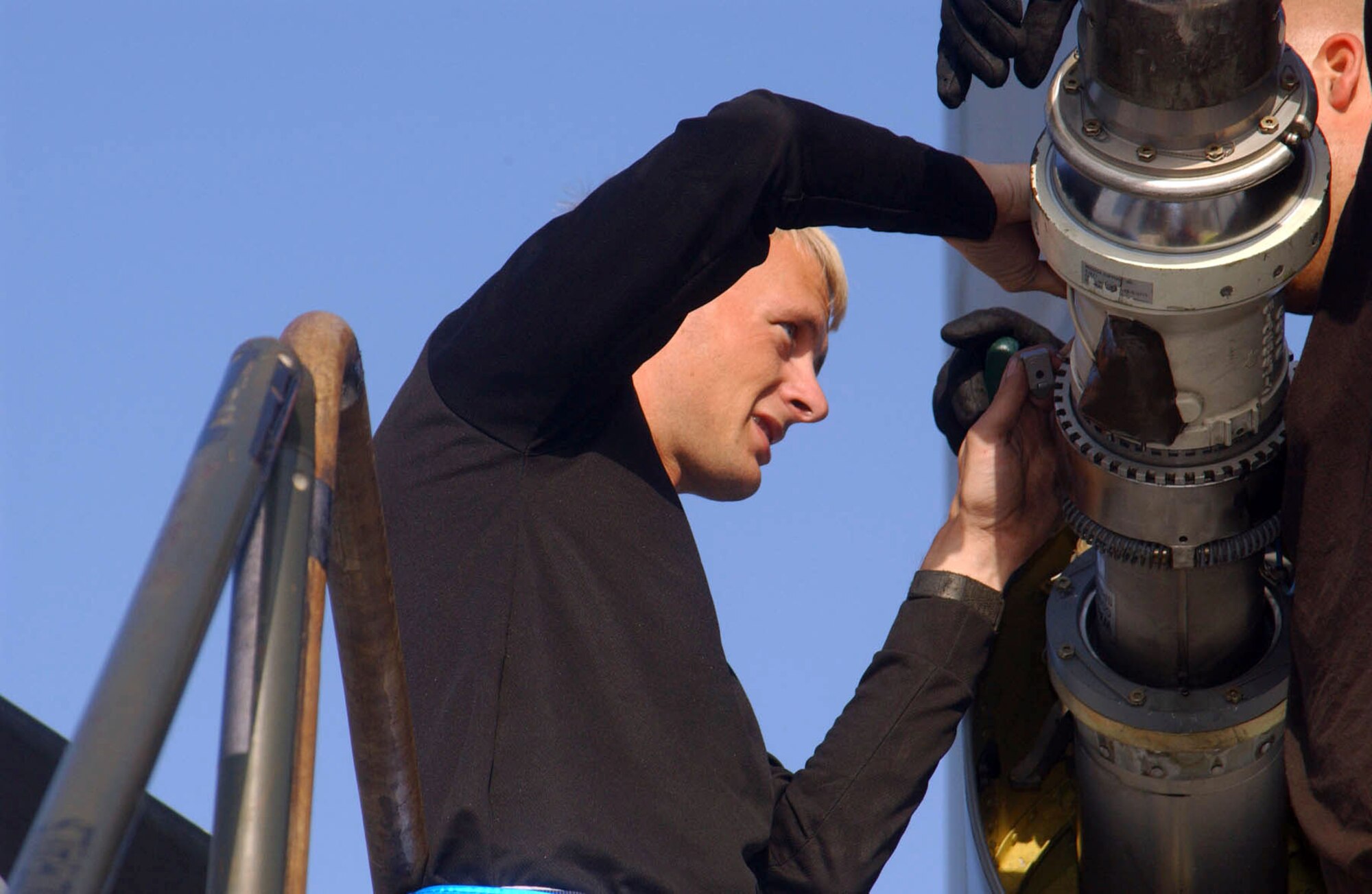 SOUTHWEST ASIA (AFPN) -- Senior Airman Jason Burns installs a boom nozzle on a KC-135 Stratotanker at a forward deployed location in the Persian Gulf region.  Airman Burns is with the 380th Expeditionary Aircraft Maintenance Squadron and deployed from McConnell Air Force Base, Kan.  (U.S. Air Force photo by Tech. Sgt. Mike Hammond) 