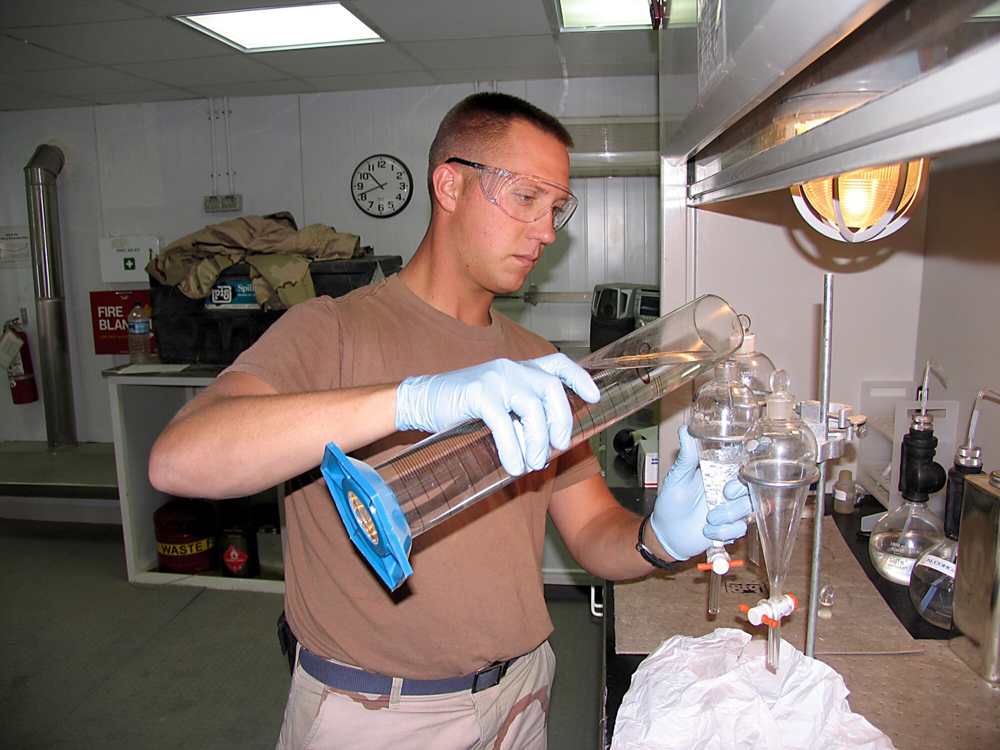 SOUTHWEST ASIA (AFPN) -- Senior Airman Mike Van Damme tests the quality of the JP-8 fuel each time a new shipment arrives.  He is assigned to the 386th Logistics Readiness Squadron fuels flight and is from Elmendorf Air Force Base, Alaska.  (U.S. Air Force photo by Tech. Sgt. Mark Getsy)