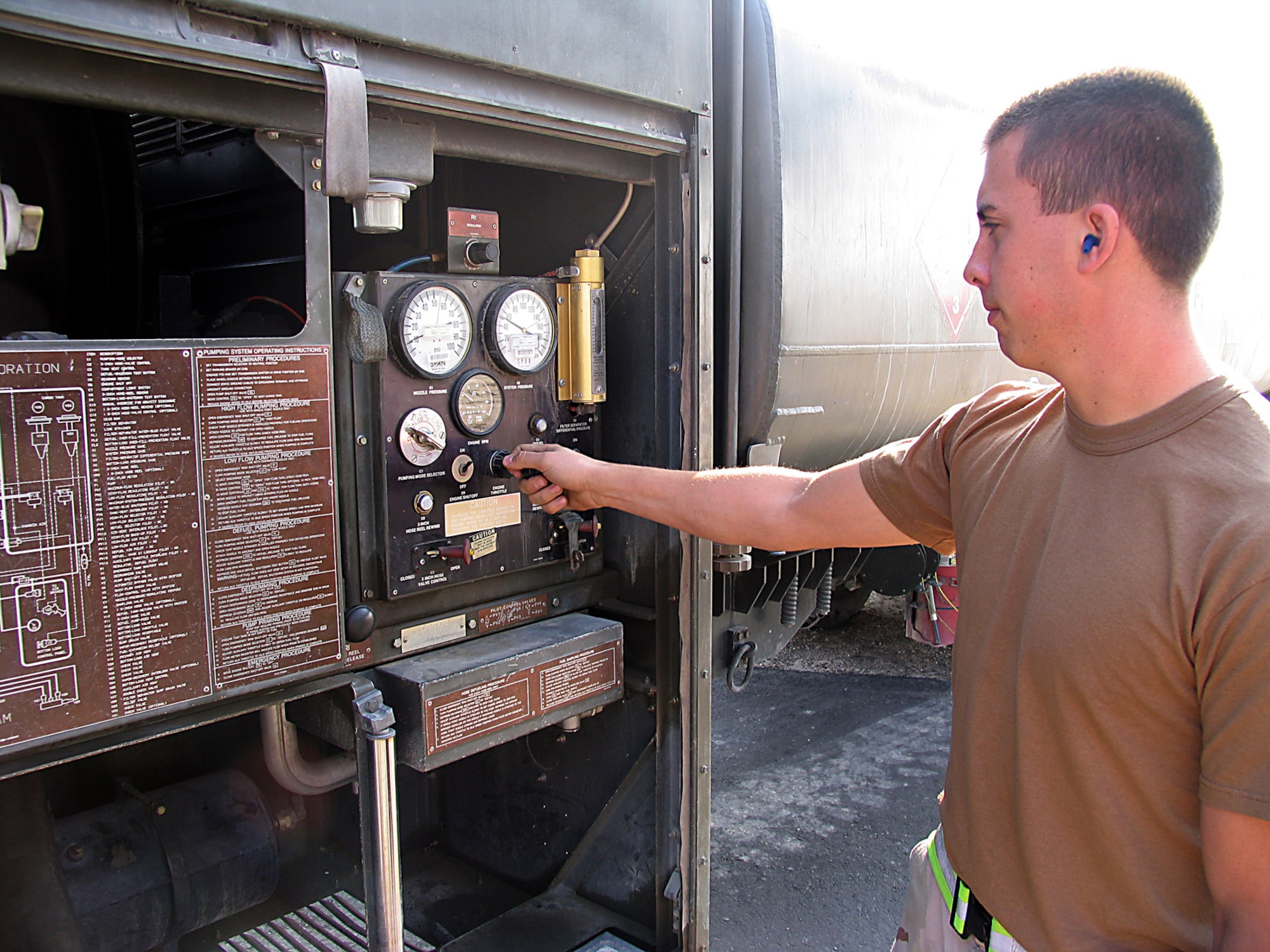 SOUTHWEST ASIA (AFPN) -- Airman 1st Class Eric Graslie opens the valves of the fuel truck to refuel a C-130 Hercules. Airman Graslie is assigned to the 386th Logistics Readiness Squadron fuels flight at a forward-deployed location and is from Elmendorf Air Force Base, Alaska.  (U.S. Air Force photo by Tech. Sgt. Mark Getsy)