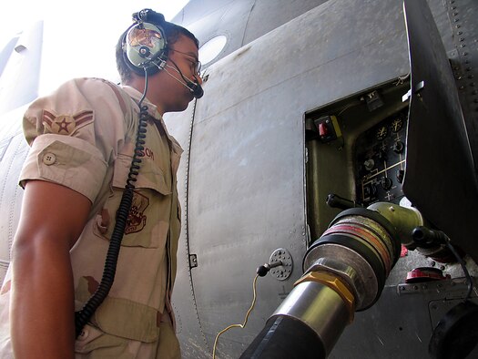 SOUTHWEST ASIA (AFPN) -- Airman 1st Class Anthony Isom hooks on the nozzle to refuel a C-130 Hercules. Airman Isom is assigned to the 386th Logistics Readiness Squadron's fuels flight at a forward-deployed location and is from Elmendorf Air Force Base, Alaska.  (U.S. Air Force photo by Tech. Sgt. Mark Getsy)

