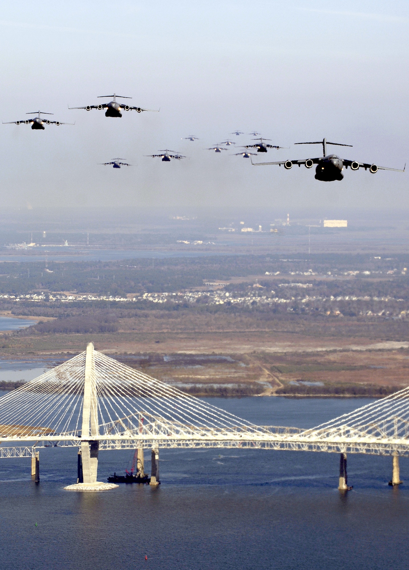 CHARLESTON, S.C. (AFPN) -- formation of 17 C-17 Globemaster IIIs fly over the Arthur Ravenel Bridge. The C-17s, assigned to the 437th and 315th Airlift Wings here, were part of the largest formation in history from a single base and demonstrated the strategic airdrop capability of the Air Force. (U.S. Air Force photo by Staff Sgt. Jacob Bailey)