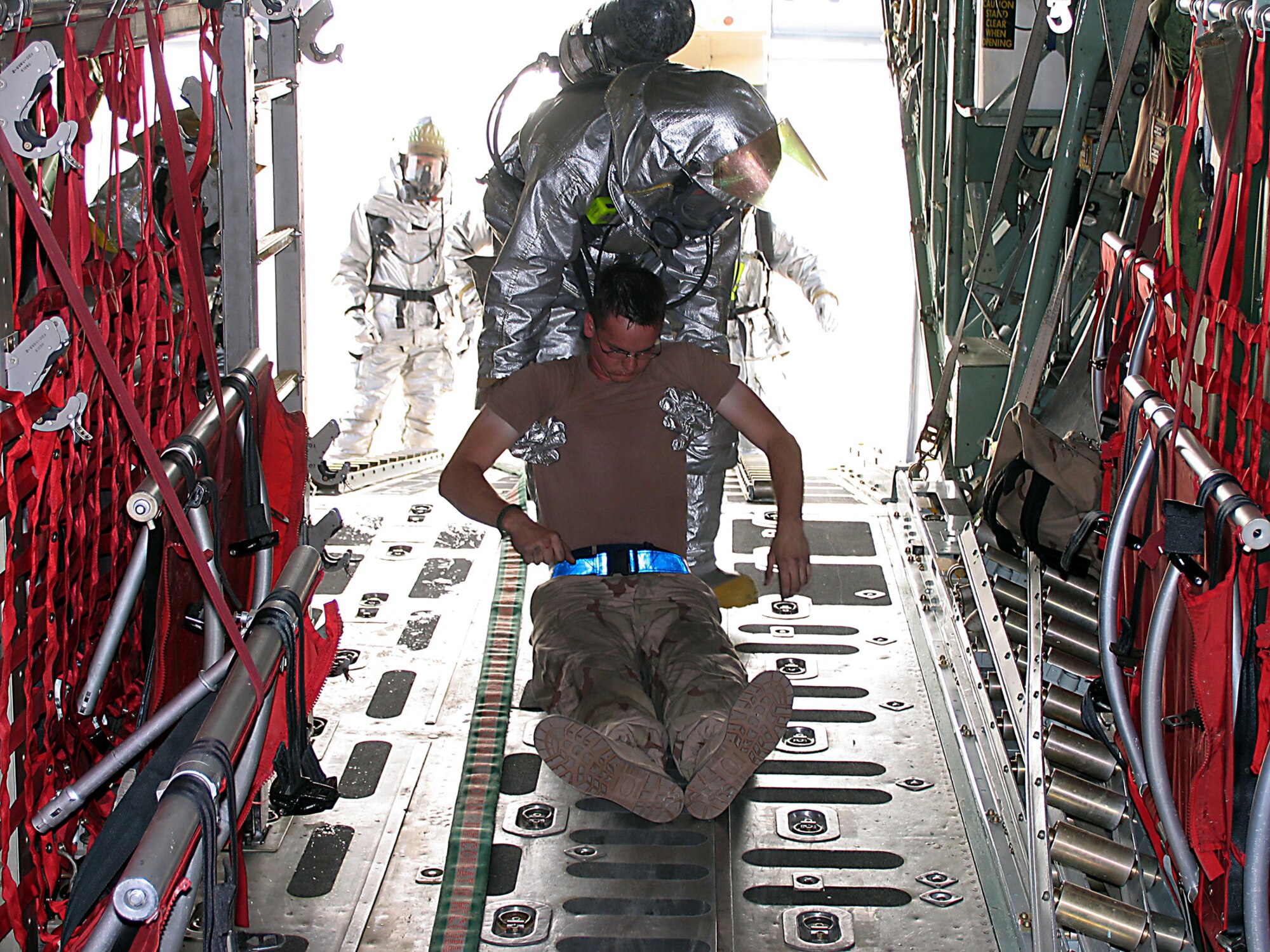 SOUTHWEST ASIA (AFPN) -- Staff Sgt. William Young pulls a "victim" out of a simulated aircraft fire. The fire department trains throughout the week to prepare for real-world incidents. Sergeant Young is with the 386th Expeditionary Civil Engineer Squadron fire department. (U.S. Air Force photo by Tech. Sgt. Mark Getsy)