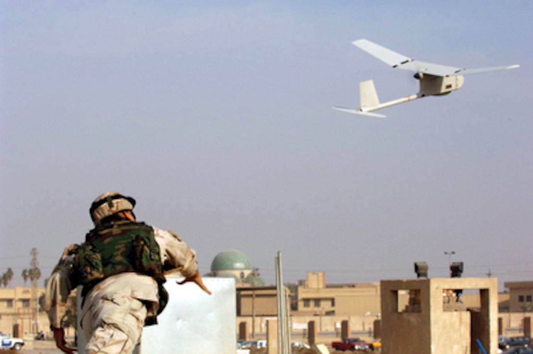 U.S. Army Sgt. Juan Rivera launches a Raven unmanned aerial vehicle into the air over Baghdad, Iraq, on Dec. 15, 2005. The Raven system is used to conduct surveillance in outlying areas in downtown Baghdad. Rivera is assigned to the 1st Battalion, 9th Field Artillery, 3rd Infantry Division. 