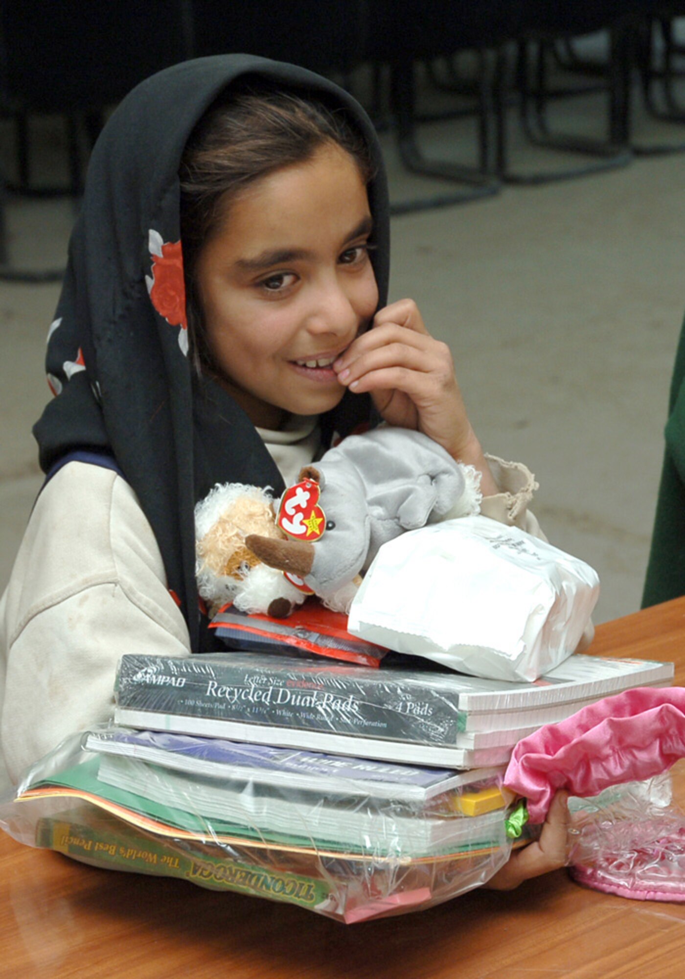 BAGHDAD, Iraq (AFPN) -- A young Iraqi girl receives free school supplies and toys before leaving the medical clinic here. (U.S. Air Force photo by Master Sgt. Randy L. Mitchell)
