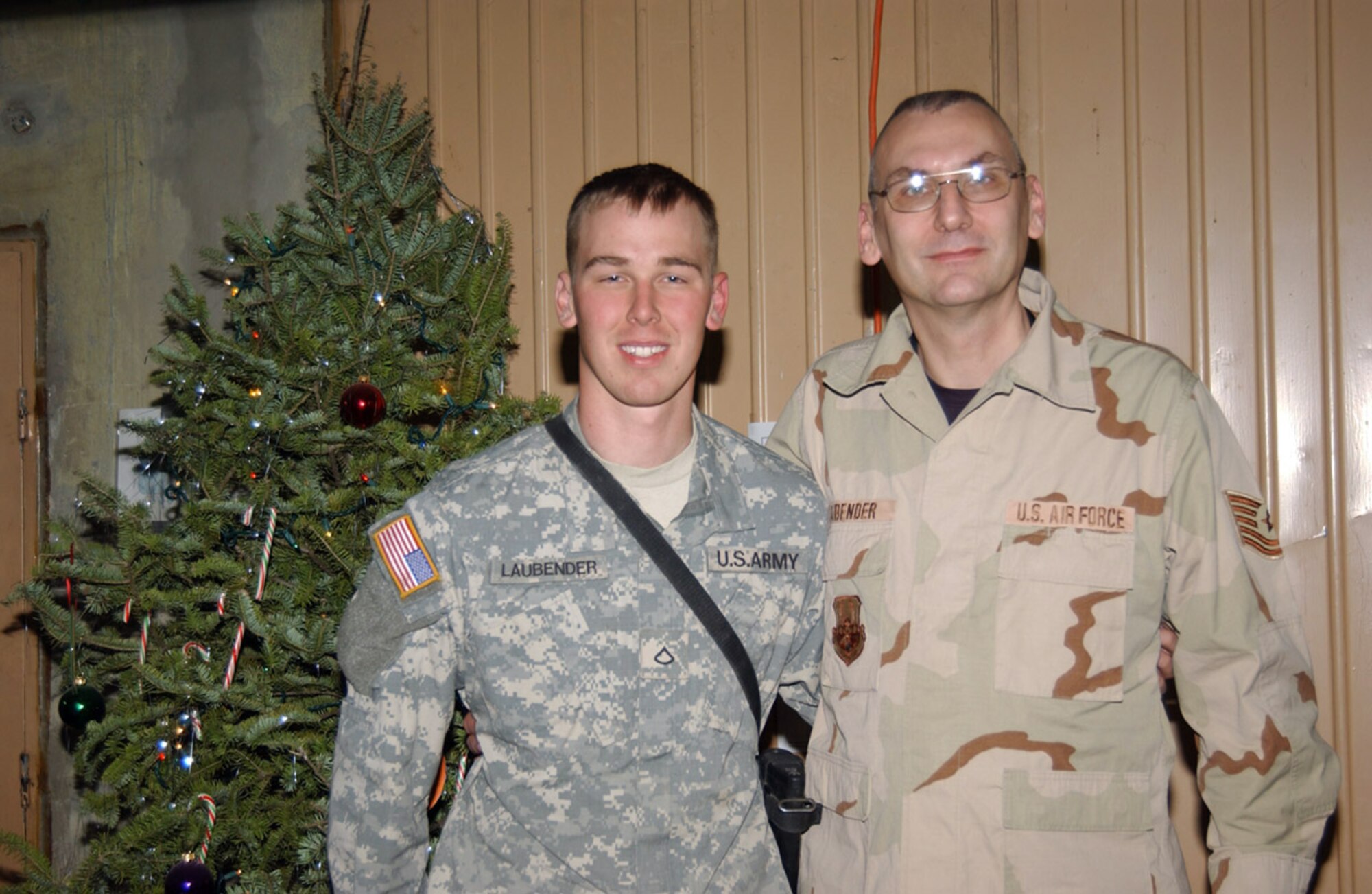 BALAD AIR BASE, Iraq (AFPN) -- Private 1st Class Andy Laubender arrived here Christmas Eve where he had a chance to spend the holidays with his father Tech. Sgt. Craig Laubender.  Private Laubender is with the 4th Infantry Division and his father is with the 332nd Expeditionary Logistics Readiness Squadron. (U.S. Air Force photo by Staff Sgt. Tammie Moore) 