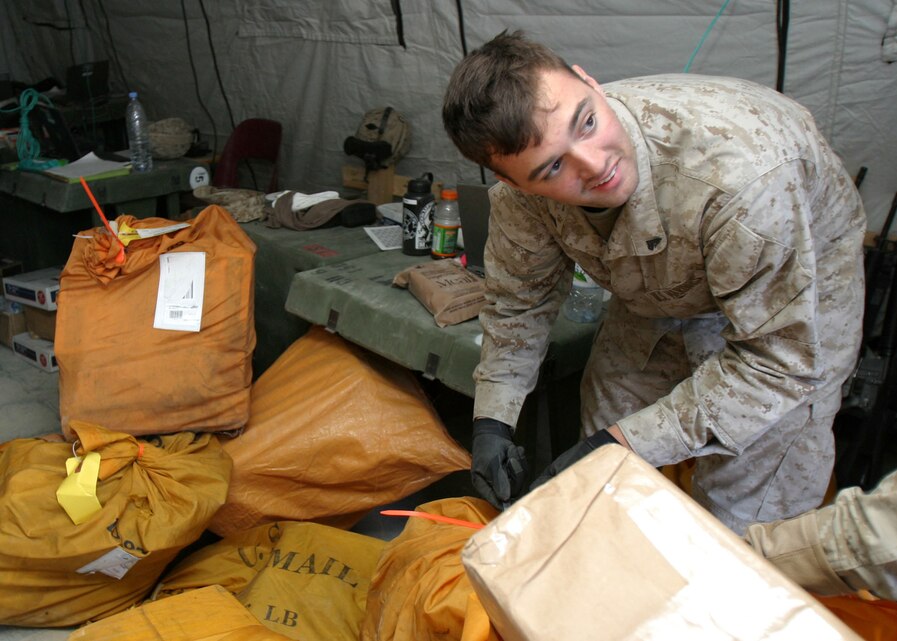 Cpl. Chad J. Albanesi, of Hudson Falls, N.Y., an administrative clerk with the 22nd Marine Expeditionary Unit (Special Operations Capable) Command Element, sorts through mail at Forward Operating Base Hit, Iraq, Dec. 26, 2005. The 22nd MEU (SOC) is conducting counterinsurgency operations in Iraq's Al Anbar province with the 2nd Marine Division.