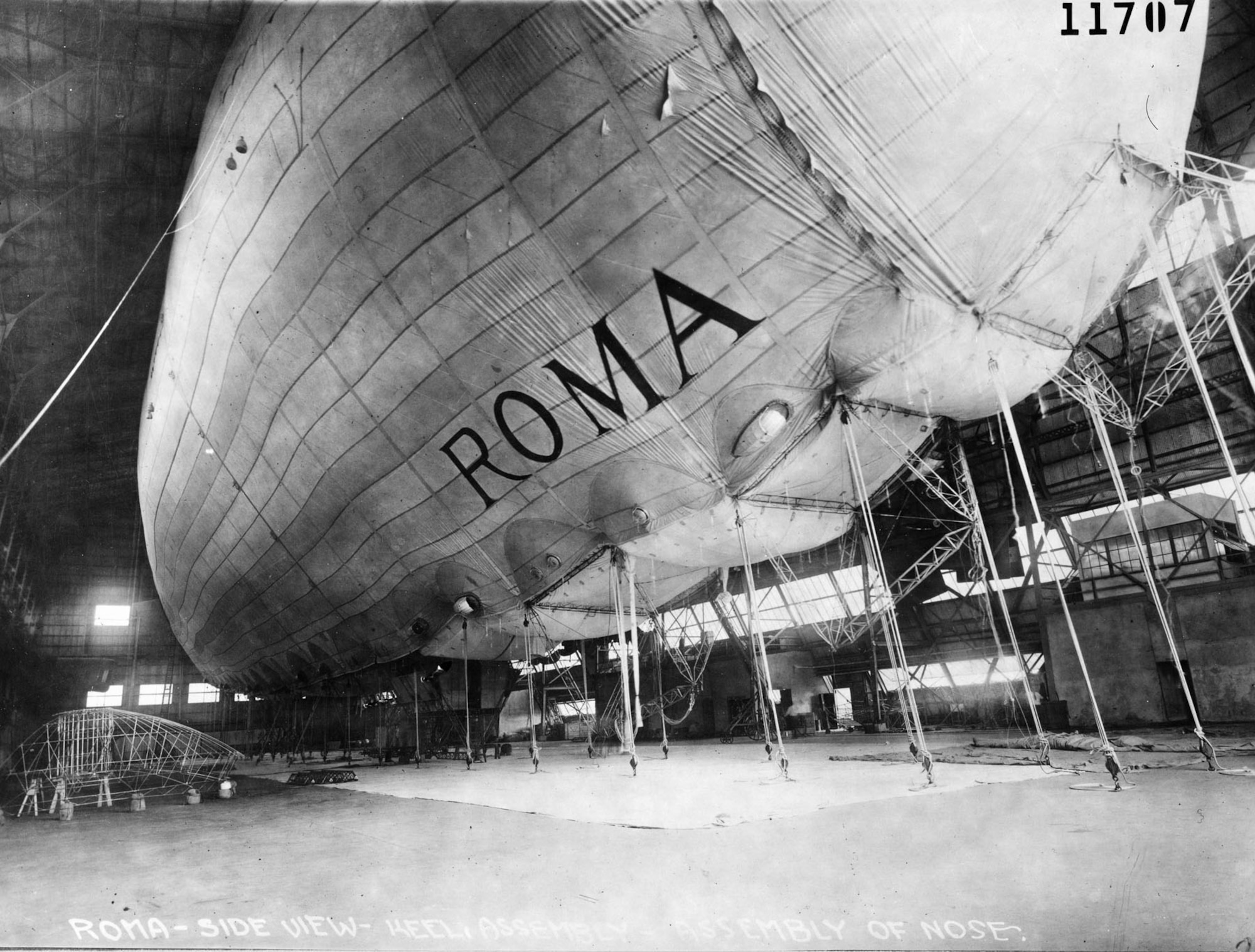 A semi-rigid airship, the Roma used hydrogen for lift, and a metal keel supported the bag. This photograph shows the metal keel being assembled. Afterward, the metal framework was covered with cloth, giving the Roma its characteristic fin along the bottom. (U.S. Air Force photo)