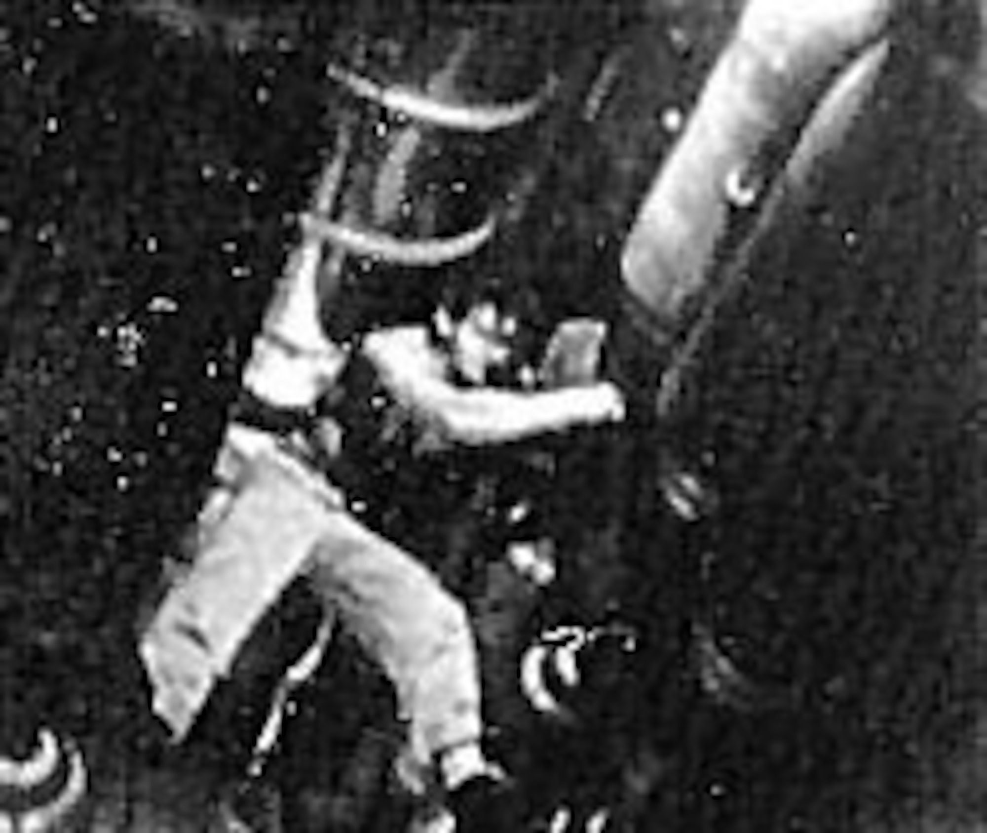 A B-29 armorer at Guam places a fuze in a 500-pound bomb. (U.S. Air Force photo)