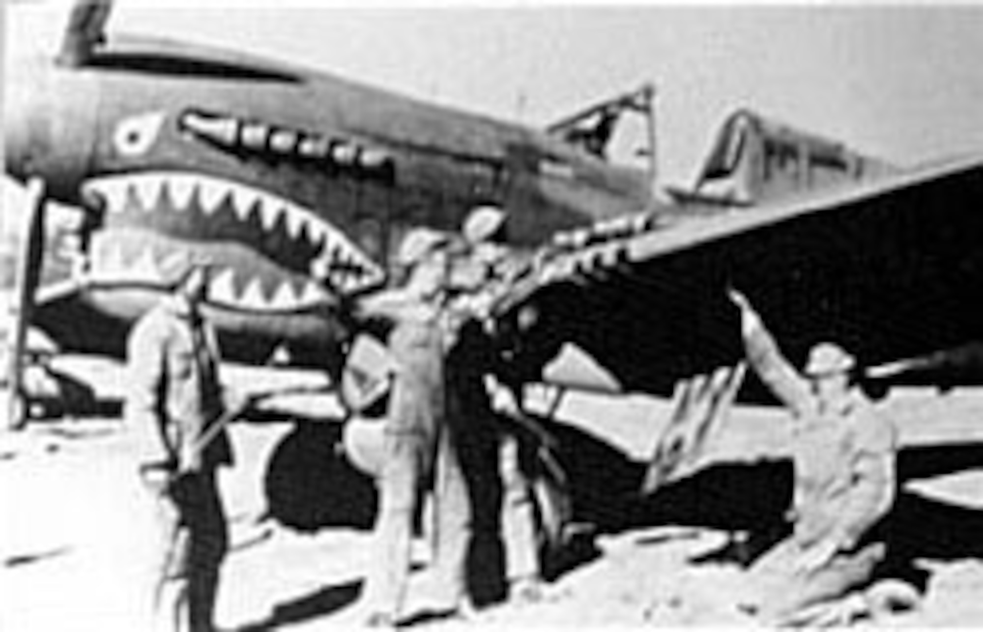 Chinese soldiers and AAF armorers clean the guns on a 23rd Fighter Group P-40 in Kunming, China, February 1943. (U.S. Air Force photo)