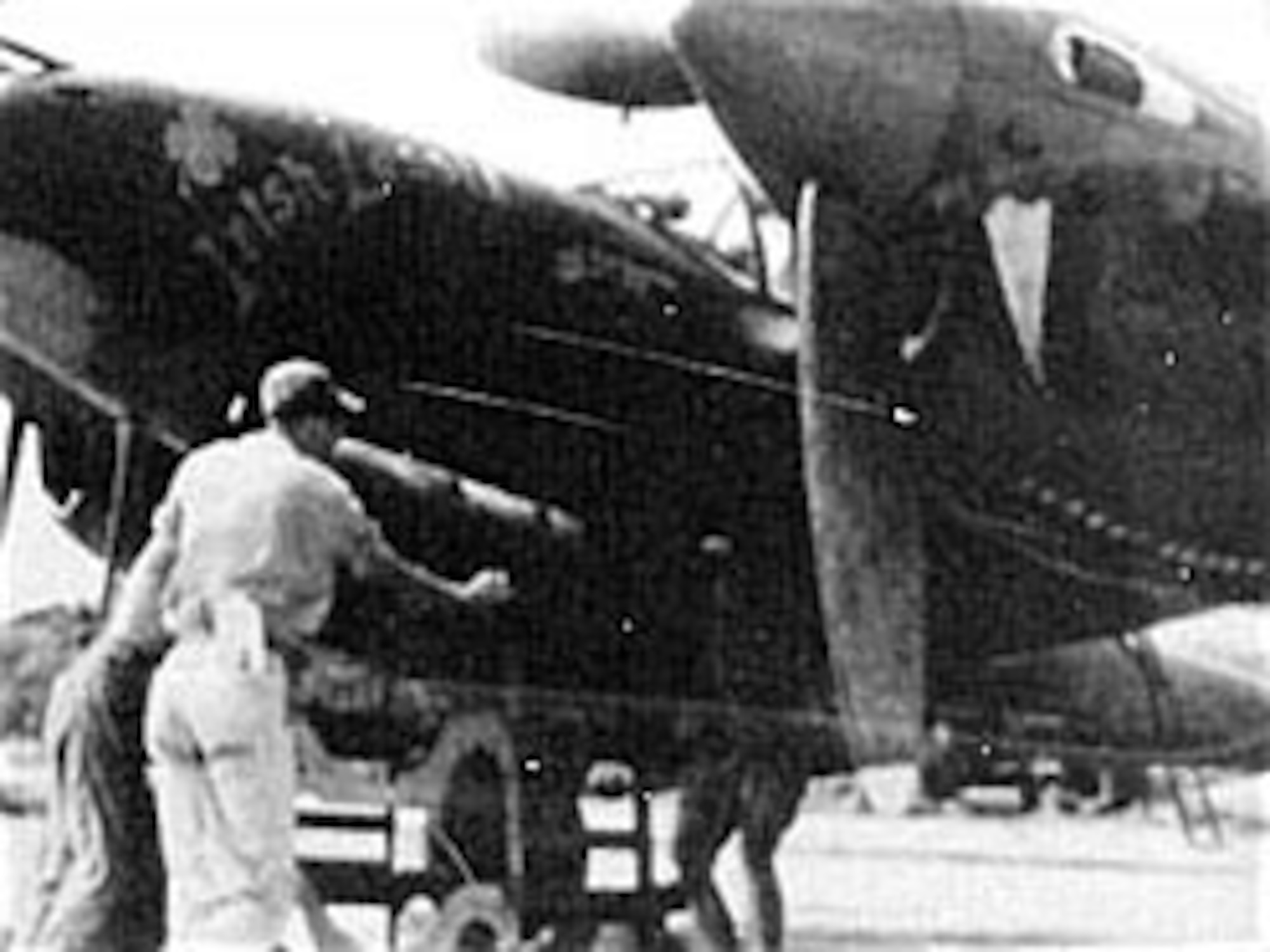 Armorers load a depth bomb on a P-38J Lightning at an airbase in India in January 1945. Such bombs could be fused for either underwater or surface targets. (U.S. Air Force photo)