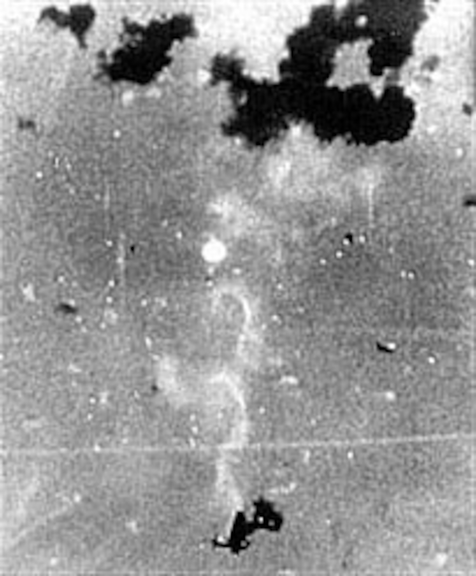 A Japanese pilot (center) parachutes to safety after his plane is blown apart by antiaircraft fire from a U.S. aircraft carrier. (U.S. Air Force photo)