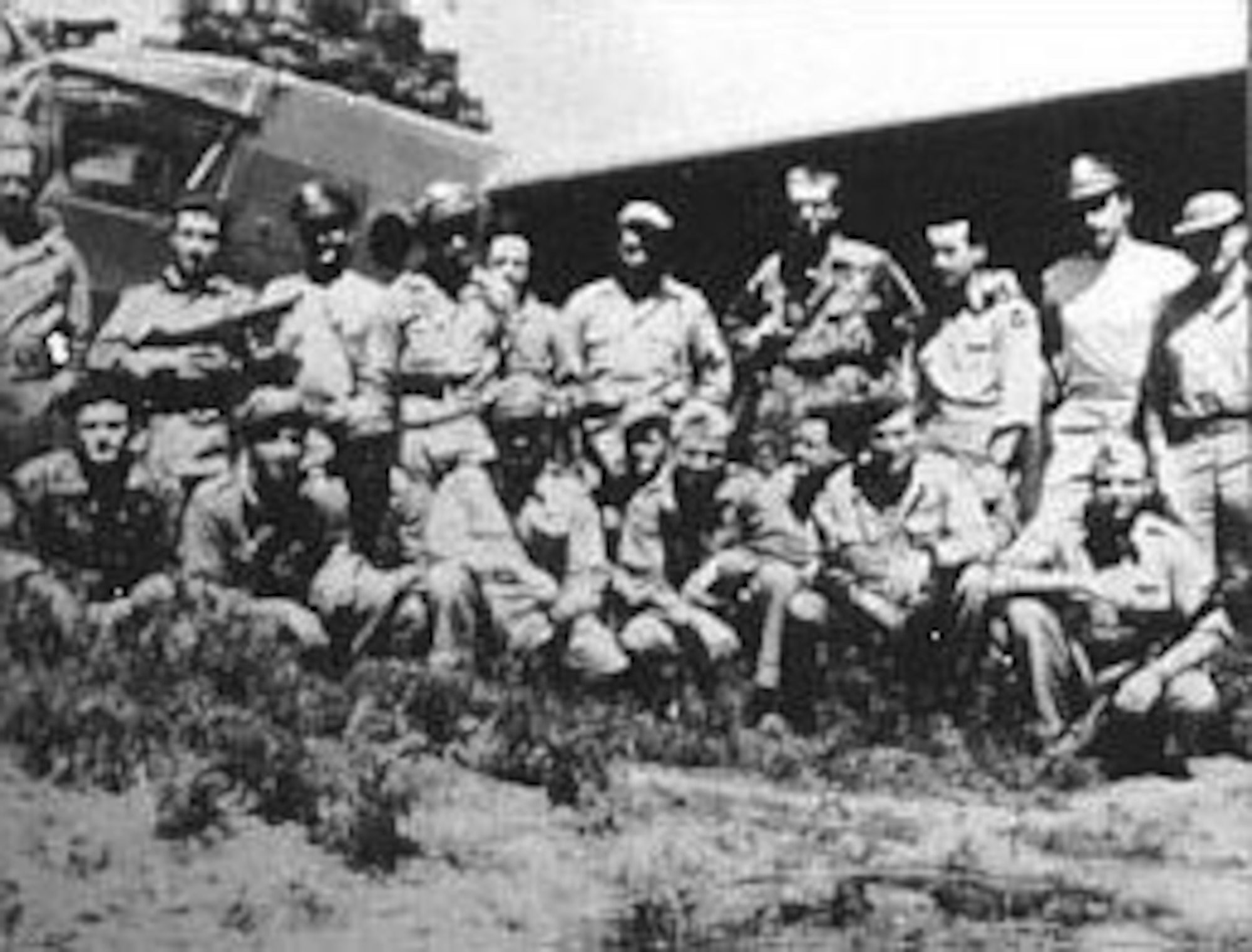 Members of the 1st Air Commando Group in India just before taking off on the glider invasion of Burma. Jackie Coogan is kneeling at right with gun on left arm. In rear is a CG-4A glider. (U.S. Air Force photo)
