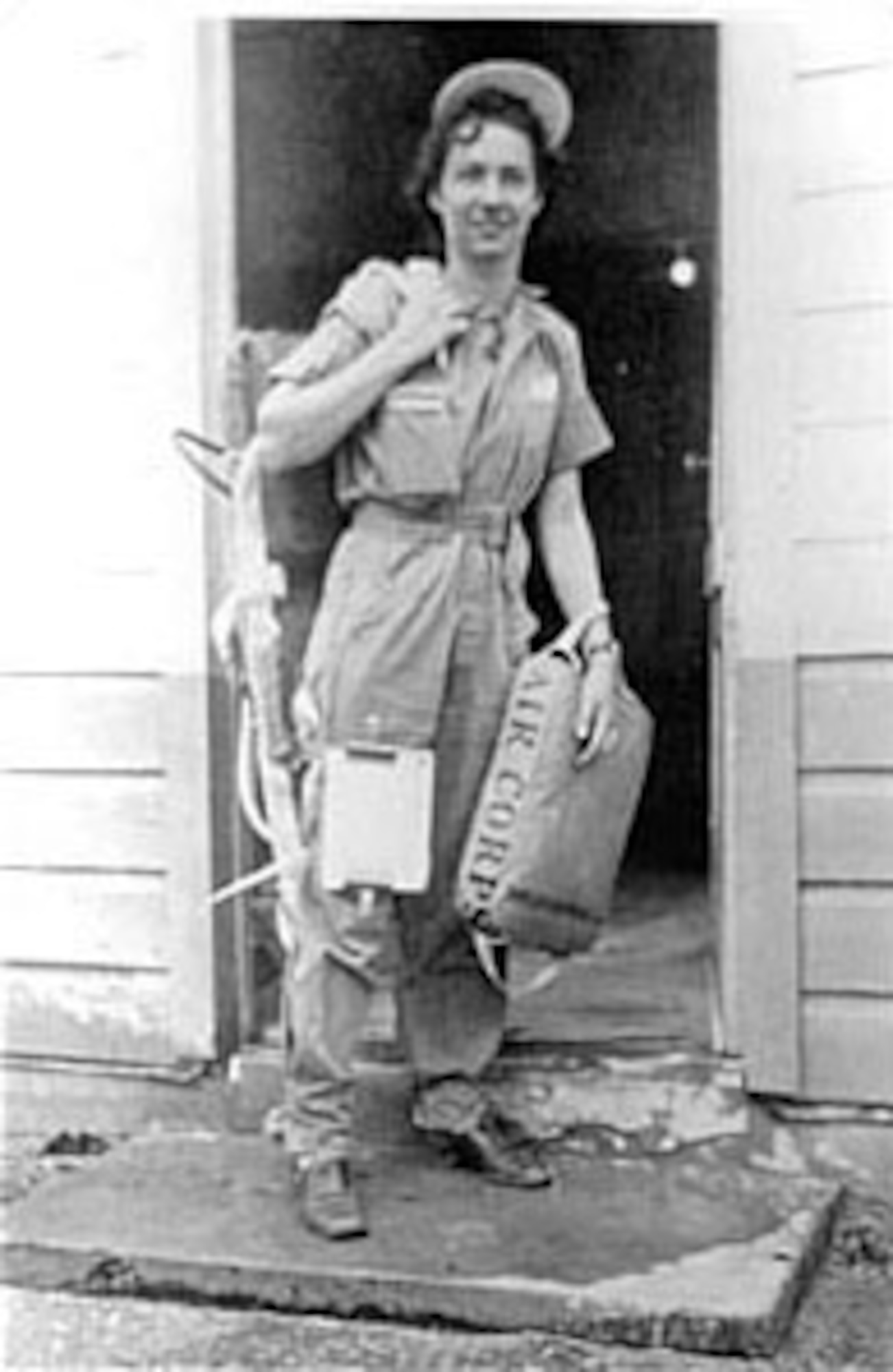 WASP Nadine Canfield (Nagle) wears flight coveralls and carries a parachute and seat cushion. (U.S. Air Force photo)