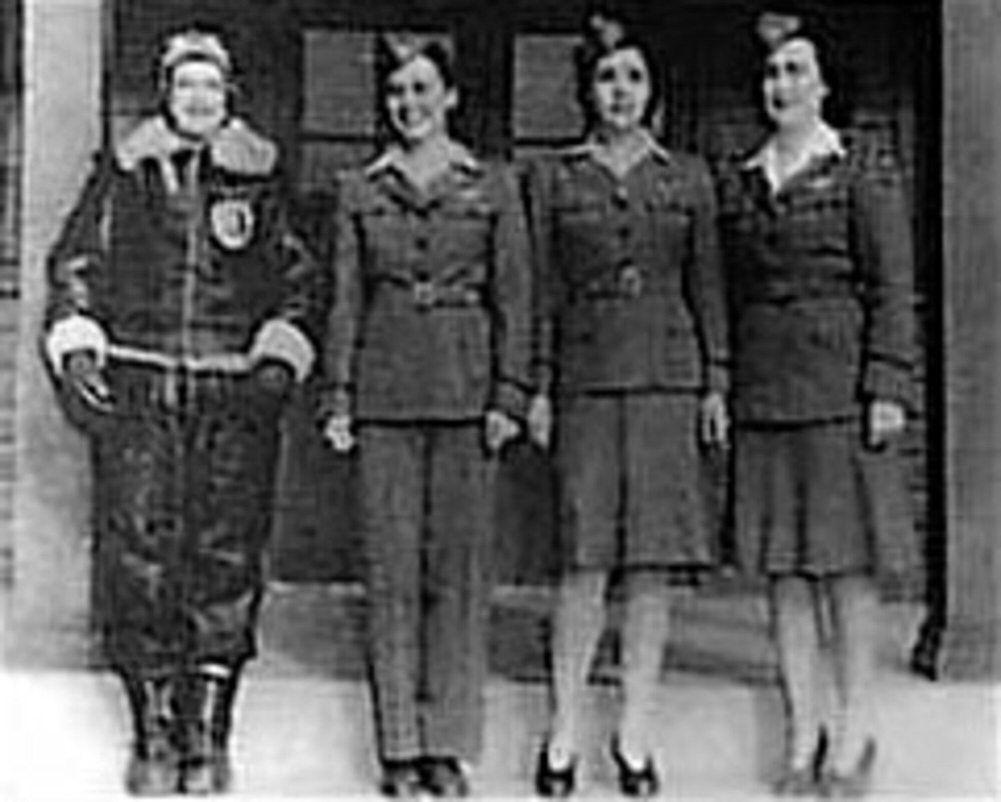 WAFS mdoel various uniforms. From left are Delphine Bohn in two piece winter flying suit; Evelyn Sharp wearing flying and traveling outfit of tan working shirt, gray jacket and trousers; Bernice Batton in same outfit but with dress skirt; and Barbara Erickson in white shirt with gray jacket and gray skirt worn for more formal occasions. (U.S. Air Force photo)
