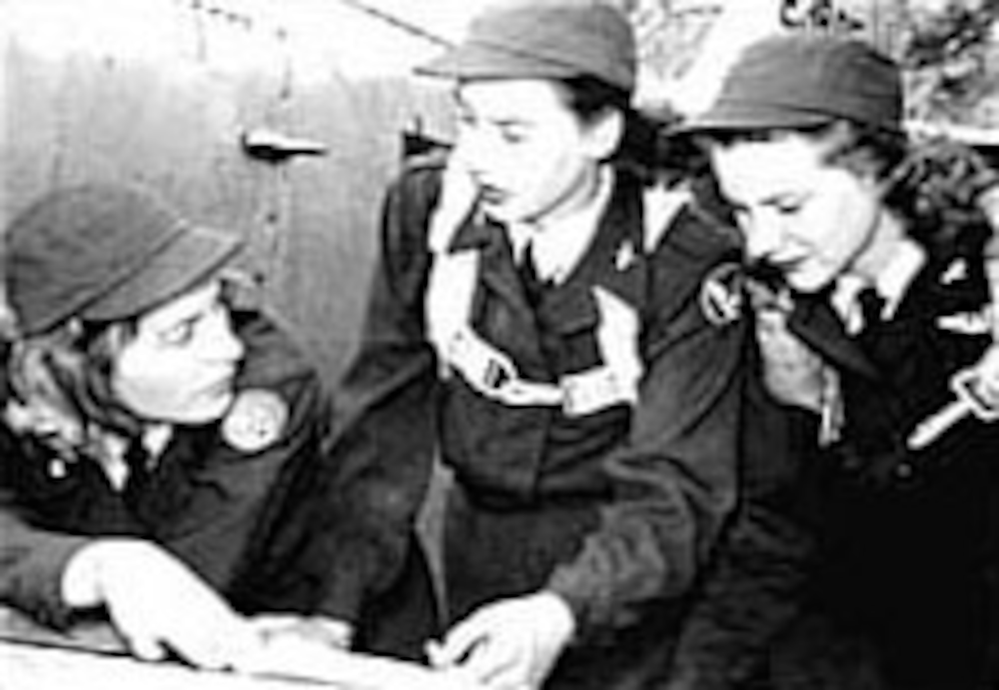 Nancy Batson (left) briefs two pilots before a flight. (U.S. Air Force photo)