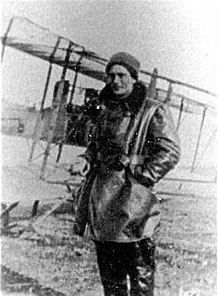 Lt. Harold R. Harris poses by a Maurice Farman training biplane in his winter flying attire.
